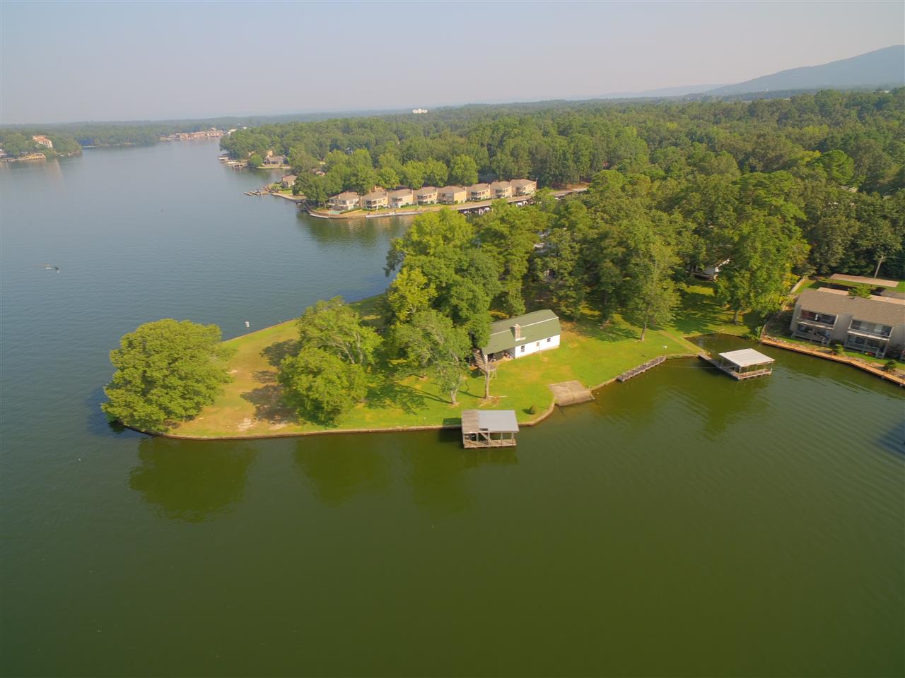 One of the last premier points on Lake Hamilton. Over 800 feet of lake frontage with a little over 2 acres. 4 older cabin/homes on the property with room to grow. Sea Wall around the whole property with 2 boat dock, boat launch, board walk, and swim pier. Tons of possibilities --Private Estate, Multiple Homes, Developmental. Come let your imagination run wild. --Most value is in the lake front property.