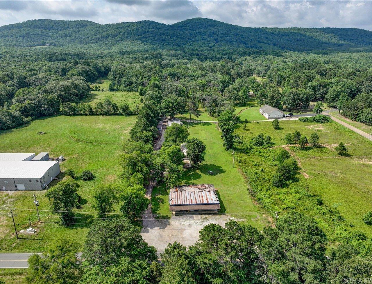 Charming old farmhouse with shops, storage buildings, and historic grocery store (3000 SF) on 2 acres. Approximately 160ft of Amity Rd frontage. Step back in time with this unique and versatile property on 2 acres of countryside charm. This classic home offers the perfect canvas for restoration or creative reinvention. Adjacent to the house (1440 sf), you will find two sizable shops (shop 1=1960 sf and shop 2= 1440 sf) ideal for wood working, automotive work, or small business operations. Additional storage buildings offer ample storage for equipment and tools. Adding even more potential, the property includes an old historic grocery store building that could be restored as a retail space, studio, or unique venue. This property offers a rare opportunity for homesteading, small business ventures, or quiet country retreat. Addresses are 3669, 3671, and 3673 Amity Rd.