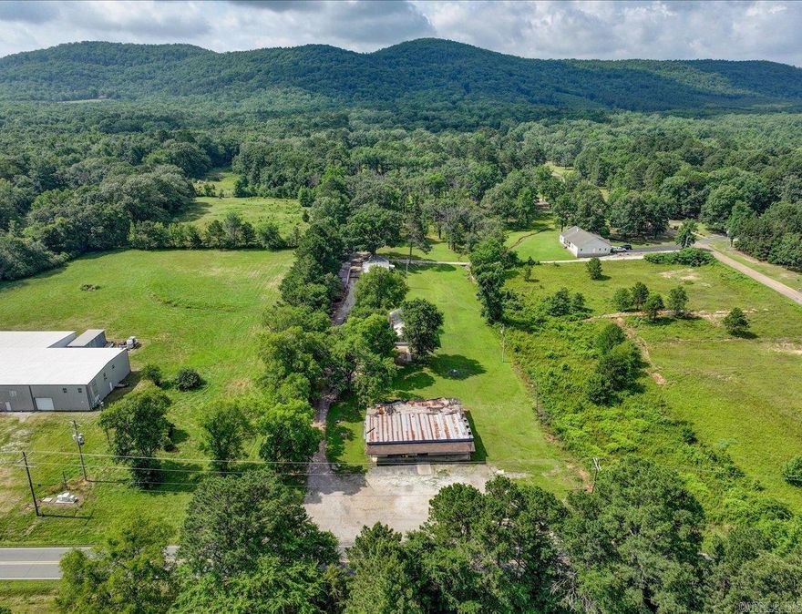 Charming old farmhouse with shops, storage buildings, and historic grocery store (3000 SF) on 2 acres.  Approximately 160ft of Amity Rd frontage. Step back in time with this unique and versatile property on 2 acres of countryside charm.  This classic home offers the perfect canvas for restoration or creative reinvention.  Adjacent to the house (1440 sf), you will find two sizable shops (shop 1=1960 sf and shop 2= 1440 sf) ideal for wood working, automotive work, or small business operations.  Additional storage buildings offer ample storage for equipment and tools.  Adding even more potential, the property includes an old historic grocery store building that could be restored as a retail space, studio, or unique venue.  This property offers a rare opportunity for homesteading, small business ventures, or quiet country retreat.  Addresses are 3669, 3671, and 3673 Amity Rd.