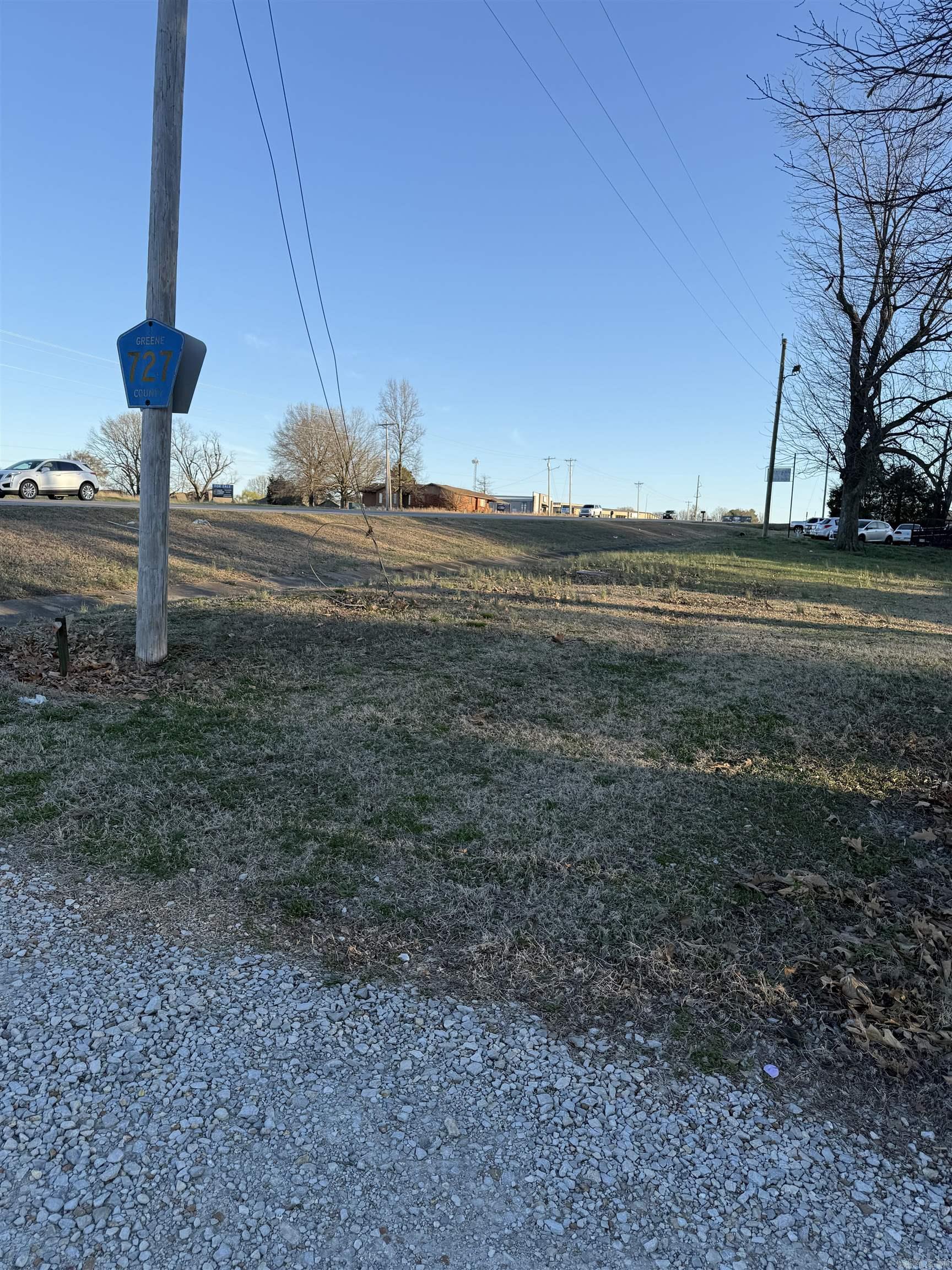 This property is unique because it has 152 ft of 49 South highway frontage. and 190 ft. deep. What is offered is recently cleared vacant land. It affords many commercial uses on a much desired highway. The fact that a county road (GR 727) runs down the right side of the property supplies access to it. Priced to sell quickly. Call for more information. 870-236-8778 or 870-240-6146