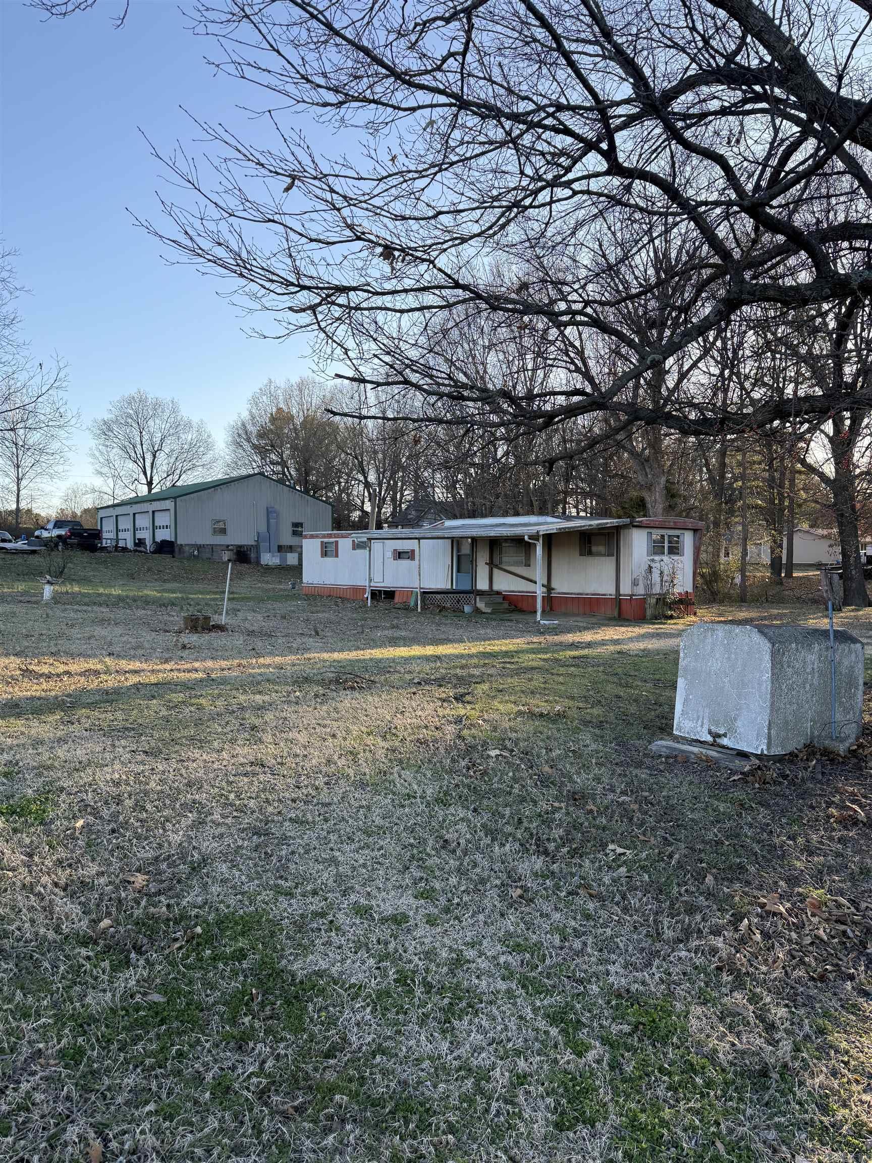 This property is unique because it has 50 yards of Highway 49 South highway frontage. What is offered is land because the mobile home is in very rough shape and storage building is small. It affords many commercial uses on a much desired highway. The fact that a county road (GR 727) runs down the right side of the property supplies access to it. Priced to sell quickly. Call for more information. 870-236-8778 or 870-240-6146