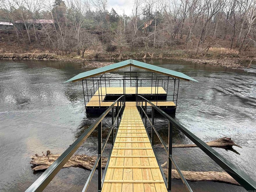 New construction on the Little Red River with a private boat dock! This beautiful home is nearing completion and is expected to be finished within the next few weeks.  The home features a desirable split floor plan designed for comfort and privacy. Enjoy river views from the spacious living room and the primary suite, both offering French doors that open onto a large covered back porch overlooking the water and your private boat dock.  Inside, the home is designed with gatherings in mind. The spare bedrooms include built-in bunk beds, making it perfect for hosting family and large groups. Whether you're looking for a full-time residence, weekend getaway, or investment property, this riverfront home offers the perfect setting for relaxing and enjoying life on the water.