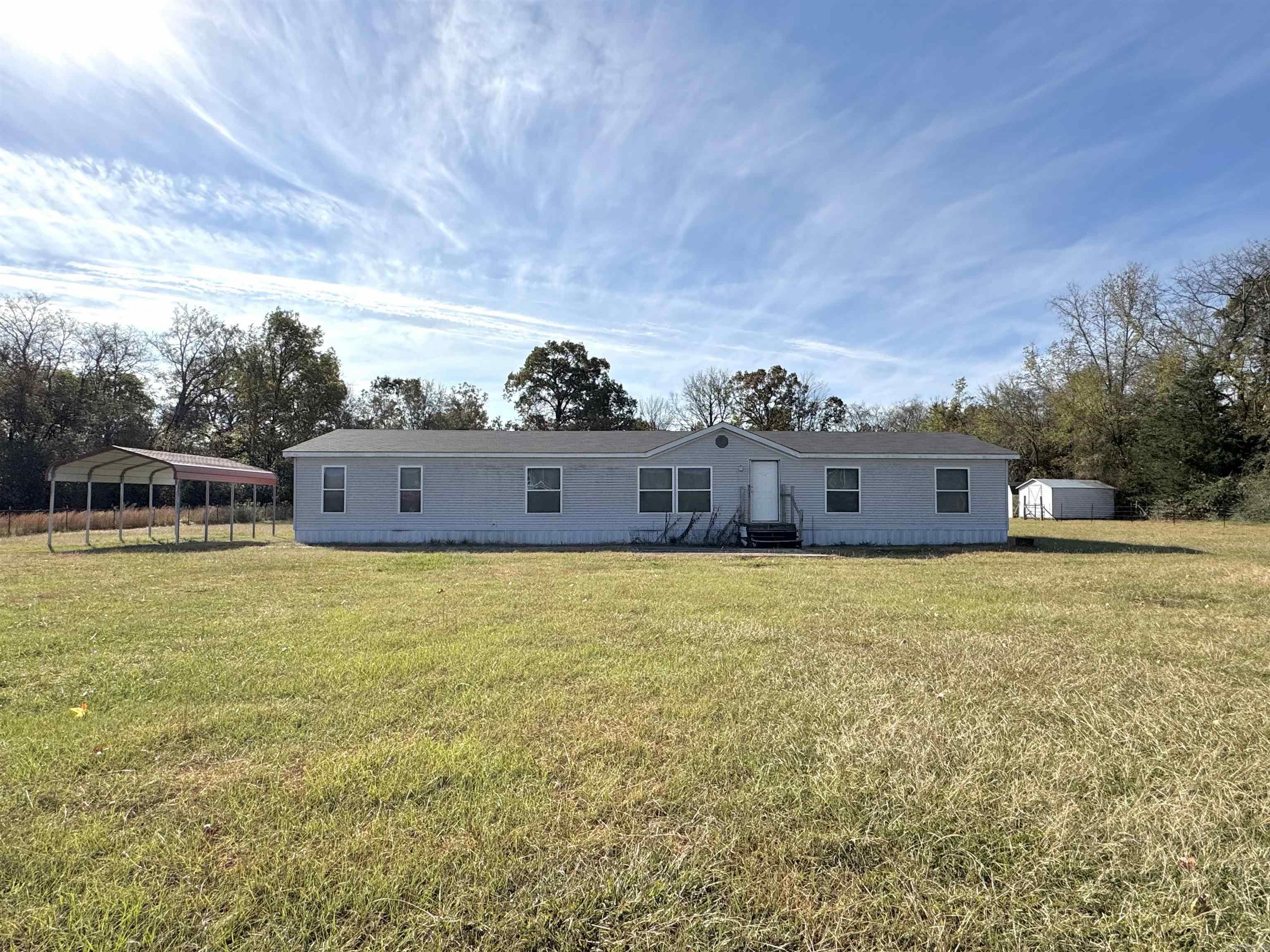 Great opportunity for those seeking country living with plenty of space. Situated on 11.23 acres that is fenced and crossed-fenced, you will have an ample amount of space for livestock, gardening, or outdoor activities. The land offers versatility and potential. Bring your imagination and come see the potential of this one-of-a-kind property today! The roof is only two years old! Agents: SEE REMARKS!