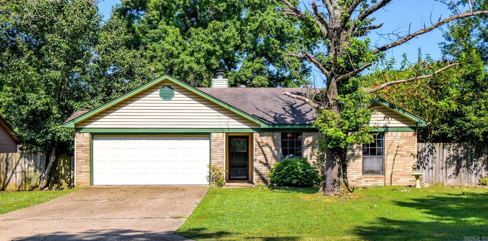 Cozy 3 bedroom 2 bath home with a welcoming living room and beautiful fireplace that flows easily into the kitchen with a breakfast bar, plenty of cabinet space, refrigerator that conveys and gas stove/oven. The laundry room is nestled between the kitchen and the 2-car garage with washer and electric dryer that also both convey. The primary bedroom/bathroom suite are spaciously comfortable with 2 walk in closets and a soaking tub with shower. Enjoy the patio in the back yard, the lovely shade tree or gardening in the level yard, surrounded by a wood privacy fence. Close to Hill Farm Elementary and Bryant Jr. High, this home has everything you need for comfortable, everyday living.