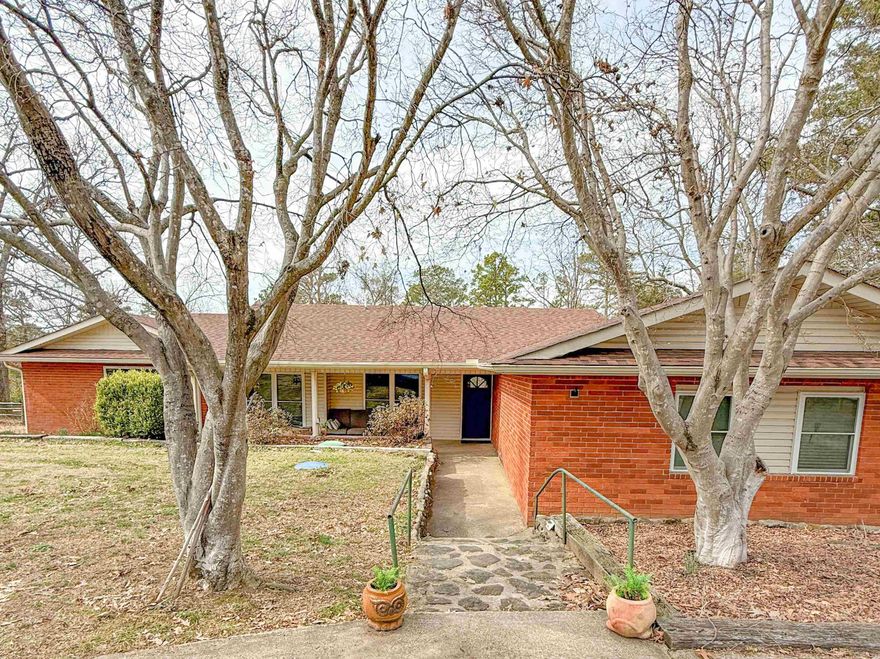 Welcome to the Market! Enjoy lakeside living in this beautiful brick home on the shores of Greers Ferry Lake. This spacious 4-bedroom, 2-bath home offers 2,470 sq ft of comfortable, open-concept living—perfect for family gatherings or hosting friends. Inside you will find a large kitchen with new granite countertops and backsplash, new carpet in the bedrooms, and fresh upgrades throughout, including a new roof, windows, and gutters. The large laundry room adds convenience, while the separate master suite provides privacy and comfort. Relax by one of two fireplaces, or unwind in the screened-in porch overlooking the large backyard with an easy walk to the water. Located just 4 minutes from Devil’s Fork Boat Ramp and 2 minutes from the Narrows Boat Ramp, this home is ready for lake season—don’t miss your chance to see it!  Agents: see remarks.