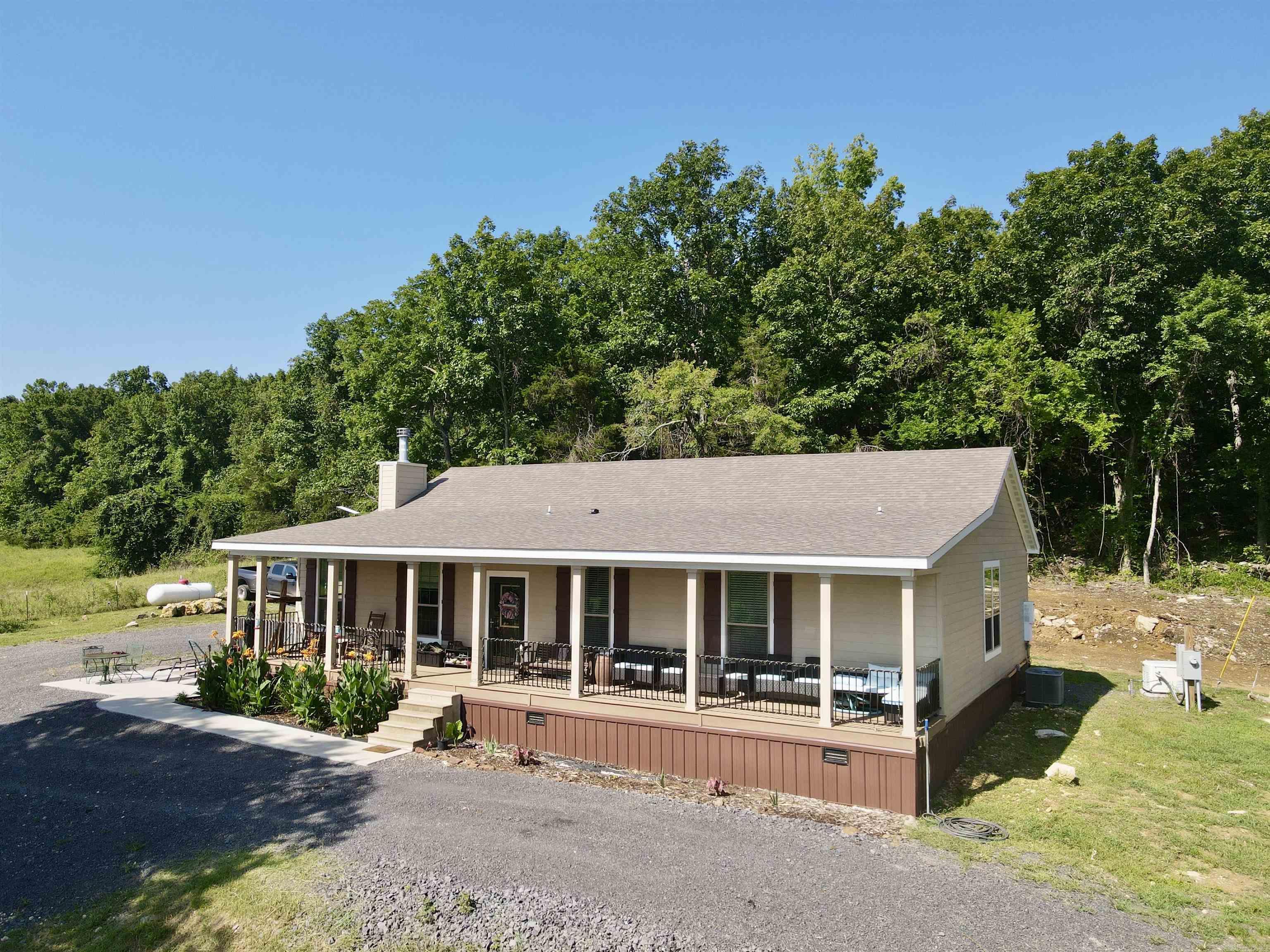 Beautiful 76.75± acre property featuring a 2023-built 4-bed, 2.5-bath modular home, year-round spring, stocked ponds, and stunning views. Includes 25± acres of established pasture with the remainder in hardwoods ideal for hunting and recreation. Outbuildings include a 30x40 shop with living quarters and RV hookup, 32x32 barn with loft, lean-to, 7 stalls (with water, electric, and fans), 20x40 hay barn, chicken coop, and garden area. Also features an enclosed hunting blind overlooking a food plot. Perfect for homesteading, livestock, or a private retreat. The home also has a 26 kw Generac propane generator that will convey.