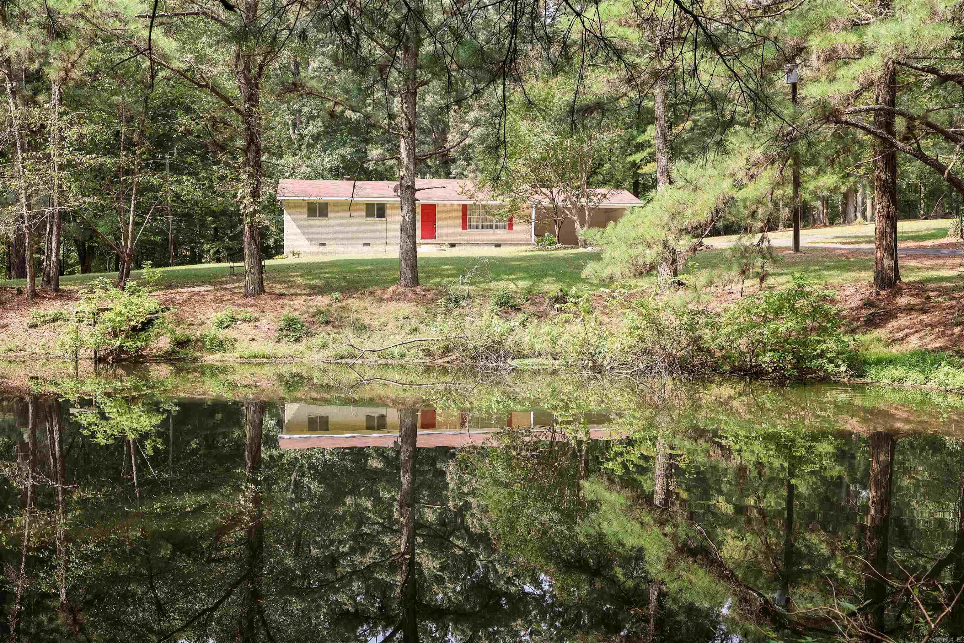 Charming brick home on 3.52± acres just outside Arkadelphia! This 3-bed, 1.2-bath home offers 1,546 sq. ft. of living space with a practical layout. Enjoy the paved driveway, pond, and plenty of space for outdoor activities or future plans.