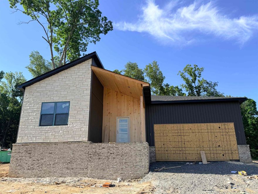 Discover this modern new construction home located in the desirable Cabot School District. This stunning property features an open layout perfect for today's lifestyle. The gourmet kitchen boasts ceiling height cabinets, a marble island, a wall oven, and a microwave, along with a large walk-through pantry that provides easy access from the garage. The spacious area allows for a dining table or a cozy sitting space, while accent walls and a built-in desk with lighting add a touch of elegance to the living area. The primary suite is designed with relaxation in mind, featuring a wet room shower with a soaker tub, a double vanity, and a large walk-in shower. Two additional bedrooms are thoughtfully separated from the primary suite, along with an accompanying bathroom. Step outside to the back patio adorned with beautiful wood accents, offering a serene view of the surrounding wooded oasis. This unique home is truly one-of-a-kind, perfect for those seeking luxury and comfort in a family-friendly neighborhood.