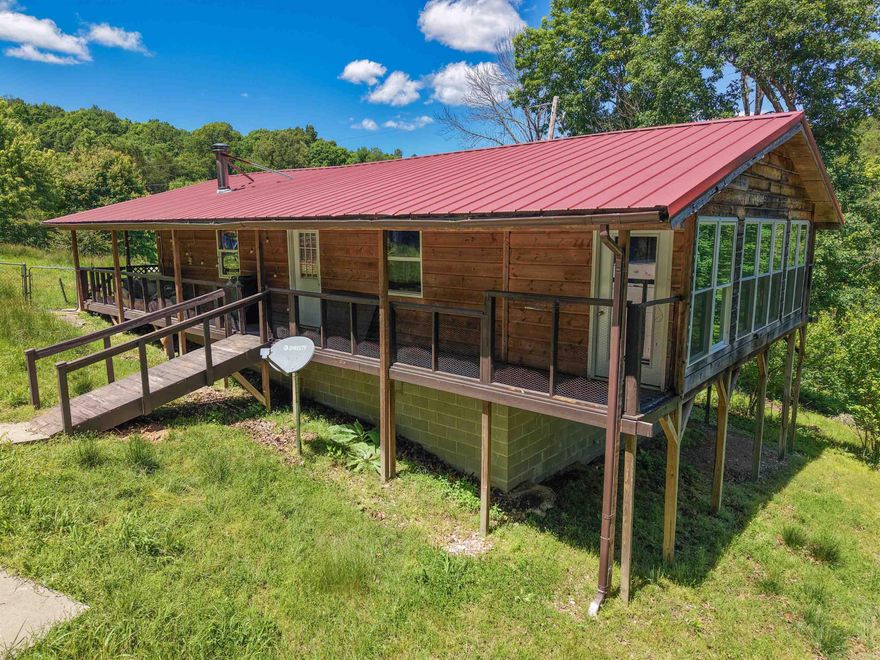 Escape to the Ozarks with this cozy wood cabin on 78.84± acres in Marshall, AR. This one-of-a-kind property offers the perfect blend of rustic charm and modern convenience—ideal for a private retreat, hunting property, weekend escape, or Airbnb investment. Located just over 4 miles from South Maumee Buffalo River access, you’ll enjoy endless outdoor adventures like kayaking, hiking, and fishing. The land features a seasonal creek, spring, unique rock formations, and scenic bluffs. Cleared pasture is perfect for livestock or hunting, and numerous trails offer space to explore. Inside the cabin, you’ll find an open-concept living area with a cozy wood-burning stove and plenty of space to relax. Fiber optic internet brings high-speed connectivity, and a third bedroom or office with large windows captures stunning views of the natural surroundings. Don't miss this rare opportunity to own a peaceful retreat in the heart of the Ozarks!
