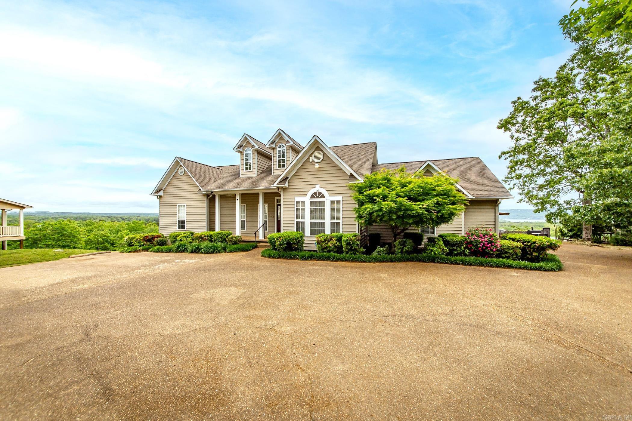 INCREDIBLE VIEW of Greers Ferry Lake & The Ozark Mountains! Come in & unwind by the serene gas log fireplace in the great room. You'll find numerous high end fixtures, maple cabinets with granite counter tops. This home has a charming covered front porch and large rear deck to entertain family and friends. This property has 2 nice shops (24x30 & 30x50) with plenty of room for all you lake toys, yard equipment, etc.. Located in nice subdivision and quiet neighborhood. Well landscaped, low maintenance, close to town. Marina & boat launch less than 5 mins! They don't come up for sale in this neighborhood very often. Dont miss out on this one. Give us a call today.