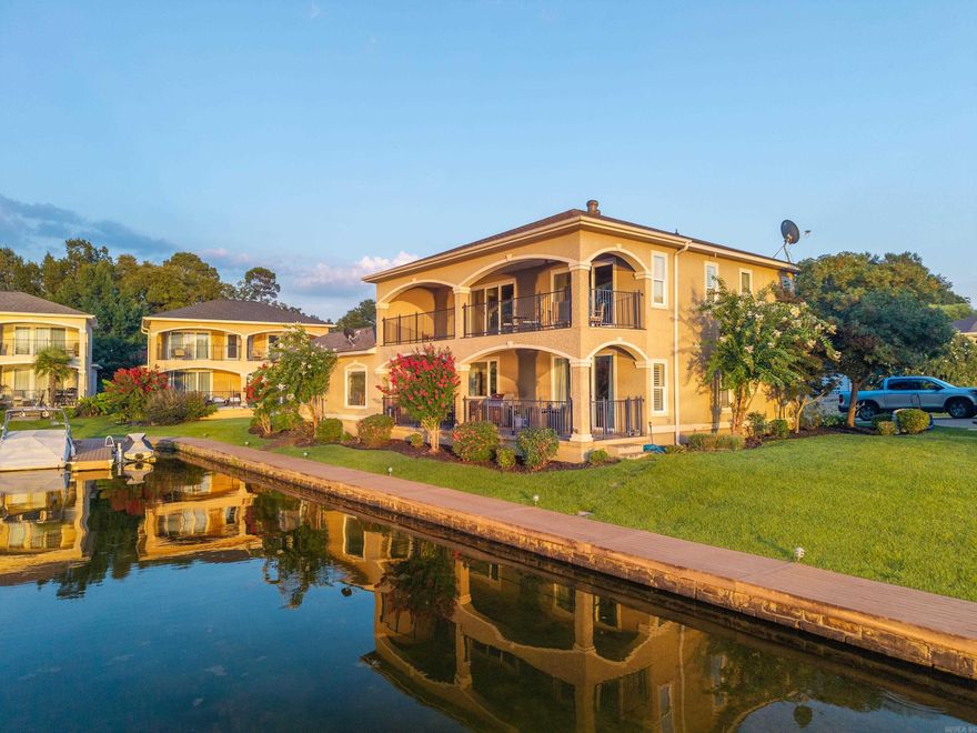 Welcome to your lakeside sanctuary where panoramic water views greet you each morning through expansive windows. This stunning 5-BR's, 3.5 Bathroom home spans 2,680 square feet of thoughtfully designed living space. The primary bedroom offers a peaceful retreat, while 4 additional bedrooms provide flexibility for family, guests. Plus, separate office. Step outside onto the large, covered patios where you can sip your morning coffee while watching the lake come alive, or host evening gatherings as the sun sets over the water. Located near the natural beauty of Garvan Gardens, this property combines tranquil lakeside living with convenient access to shopping and amenities. Whether you're seeking a permanent residence or a vacation getaway, this home delivers the perfect blend of relaxation and recreation in Hot Springs 'coveted lake community.