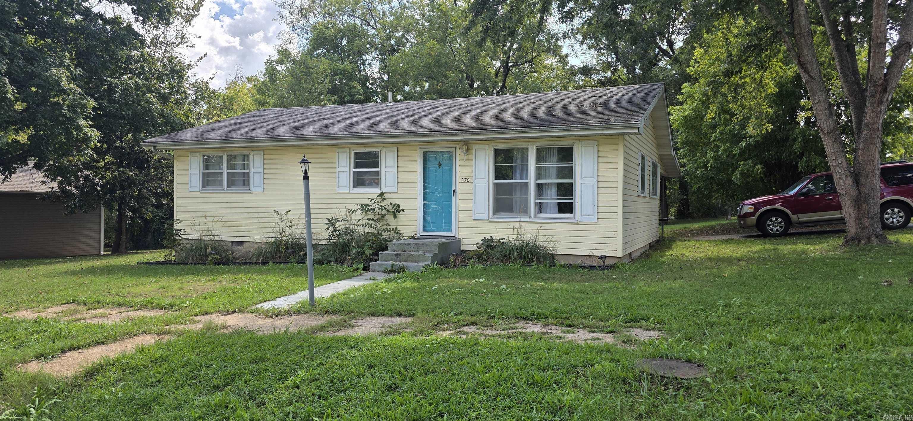 3 bedroom 1½ bath home. This amazing home is within blocks of downtown -- walk to the great shops, restaurants, and school! Easy access to Mammoth Spring State Park and Spring River for recreation and fishing. This home offers original hardwood floors. A modern kitchen with nice cabinetry and prep space, newer stone backsplash, garbage disposal. Bedrooms features original hardwood flooring, and ceiling fans. Both baths have newer tile floors and Main bath has newer tile shower. Utility closet features hook up for a stackable washer & dryer. Home has a nice attached carport with large storage area. Located on a double lot with one lot on corner with mature trees for shade, beautiful landscaping, and storage shed. This house is move in ready. You definitely must see it to appreciate it