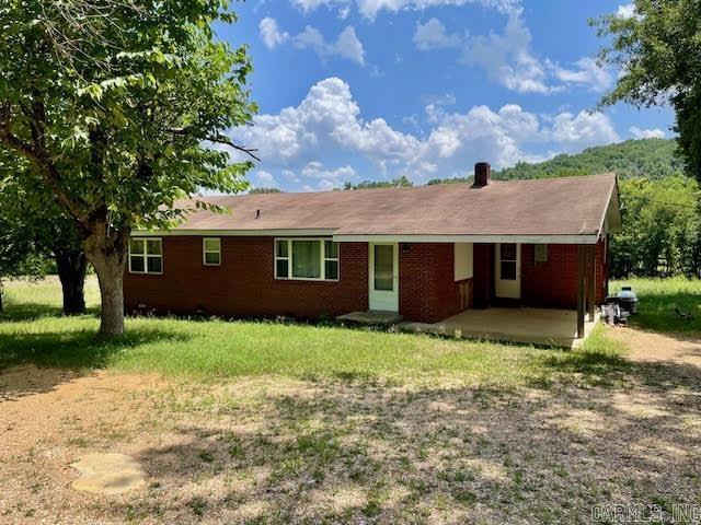 This quaint 3 bedroom 1 1/2 bath home has 1264+/- square feet of living space and sits on 5.2 acres +/- of land. The home has original hardwood floors throughout the main living area and bedrooms. The primary bedroom has a half bath for added privacy. The kitchen includes a wall oven and in counter gas cook top. A wooden deck off the back of the house provides and unobstructed view of the rolling acreage. Perfect for watching wildlife and entertaining. There is a wet weather creek that runs along the back of the property. There is also a 30x30 shop with electric for extra storage or project area. This property offers privacy, approximately 1.8 miles off of Highway 90 and only .2 miles down gravel. The brick exterior provides maintenance free care. Central heat and air are electric as well as the hot water heater. There is supplemental heat provided with a propane plaque heater.