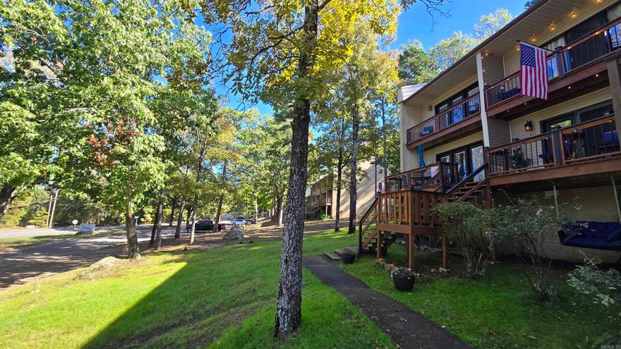 Nestled in the heart of a lake town resort community, this turn-key 2-bedroom, 1.5-bath condo is your gateway to year-round adventure and relaxation. Perfectly updated and ready for immediate enjoyment, it includes everything you need—furnished down to the linens and dishes—minus just a few cherished personal items. Step inside to gleaming new luxury vinyl plank floors that flow seamlessly throughout, complemented by fresh paint in soothing neutrals that amplify the natural light pouring through updated windows. The kitchen shines with brand-new appliances, countertops, and trendy shelving for effortless entertaining. Cozy up in the living area with plush new decor, or retreat to the spacious primary bedroom. The second bedroom offers versatility as a guest room or home office, while the full bath features modern fixtures and ample storage. Outside, vibrant green grass blankets the front and back yards, creating an inviting oasis. Unwind in the charming front porch sitting area with morning coffee, or enjoy grilling steps from the kitchen area, or head upstairs to the private balcony for sunset views . The upper deck beckons for sunset views as well!  Nearly everything can stay!