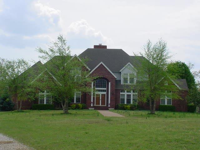 LOOK AT THIS! 156 +/- acres just 6 miles from Mtn. View's famous courthouse square. Property runs along Hwy 9, home is secluded on top of the mountain. This home is very well maintained with a soaring fireplace, custom woodwork, and Iron Works fixtures. Property includes an event barn w/2 ADA bathrooms with shower stalls, 3 ponds, 2 pastures, mature trees, bluffs lines, a "cow barn", a huge metal rec barn, and fencing. Too many features to list. 2021 AC/Heat unit installed. Deer and turkeys run a muck here!