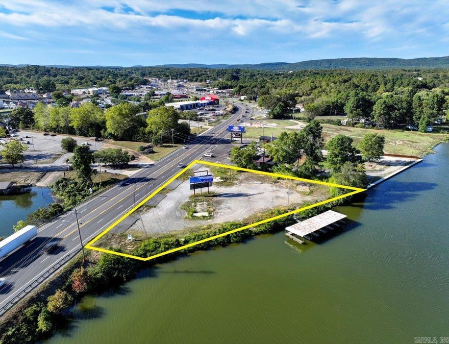 Six covered boat dock stalls and vacant land - Outstanding Commercial Lot on waterfront on Lake Hamilton, next door to Cajun Boilers and across from The Atrium Senior Assisted Living.    Income producing with billboard lease on property.  390’ Hwy 270 frontage and 380’ Lake Hamilton Road frontage Zoned C4 - Regional. Commercial City water and sewer available. 6 Permitted, Covered Boat stalls on Lake Hamilton - can be rented out for $200 a month each for a total of $1200 a month. High Traffic Count and visibility. The potential is unlimited!   Agents - Call Showing service to schedule all showings.