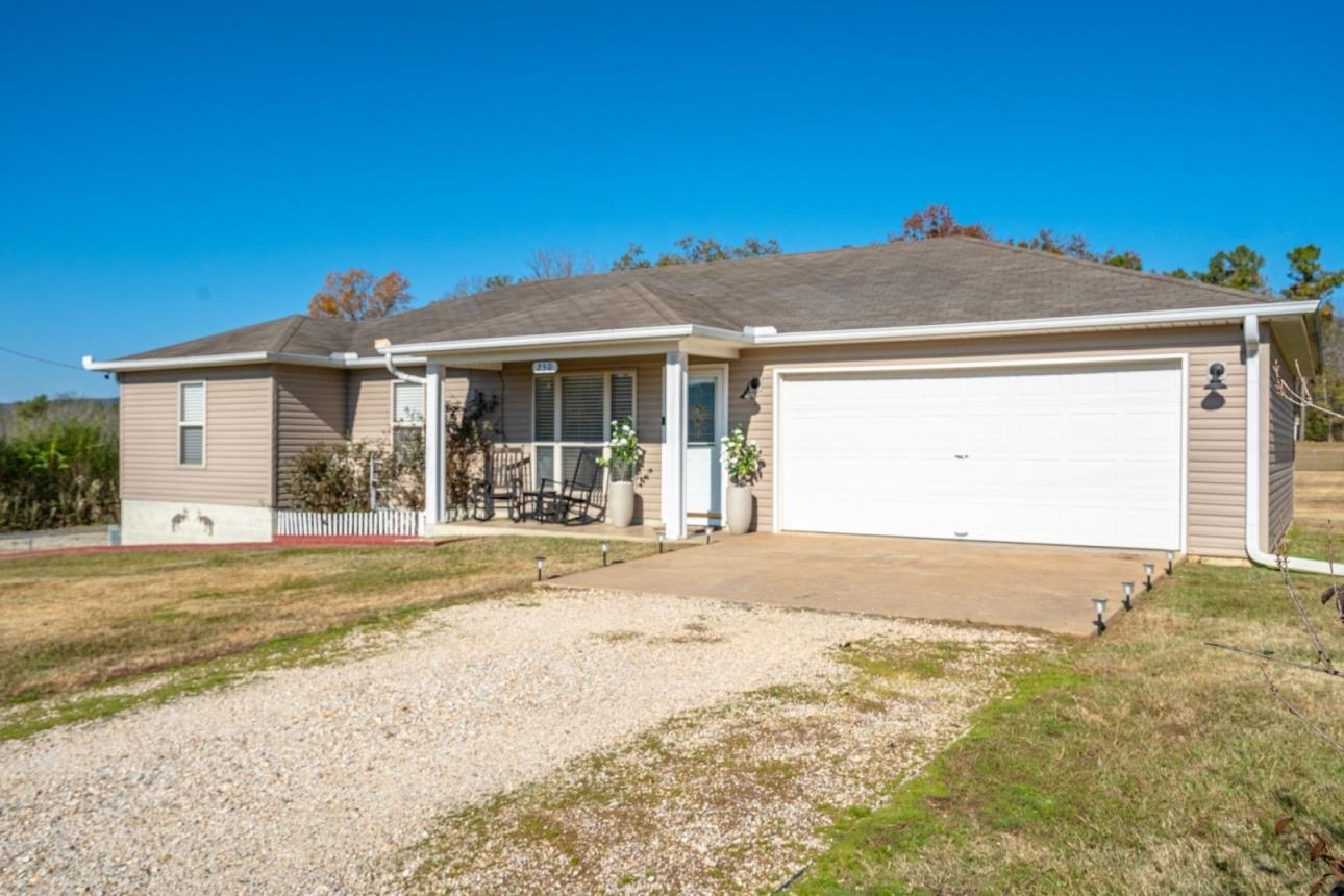 Beautiful country living home in this updated home! From the moment you pull up to your new home you will be fall in love with the inside upgrades like bright neutral colors throughout, an open floor plan perfect for the family get togethers or game day cookouts with the gang under the covered back deck patio. The large kitchen features granite counters, updated cabinets, a surface range and breakfast bar. Or gather round the family table to dinner. The living area features a gorgeous built in fireplace with glass doors and the bedrooms are spacious and comfortable. The home features a 2 car garage for mom and her toys but wait, there's also a detached garage for dad and ALL his toys! Full fenced and move in ready. What are you waiting for? Let's go!