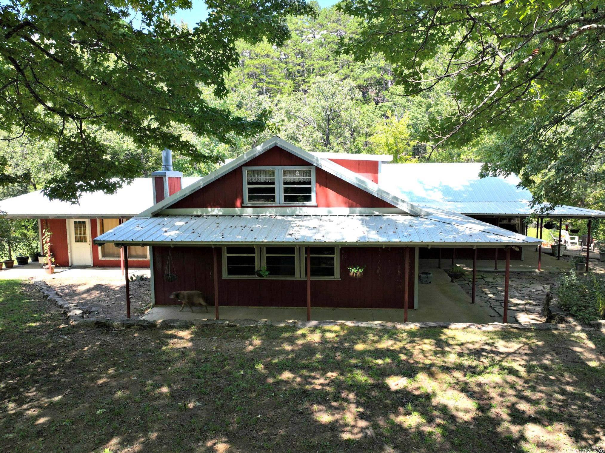 What if you could own a piece of Mack's Creek AND be on the trails in less than 10 minutes? This property fits the bill! Plus, there is another home on the property for friends. Deck steps go nearly to water, sits on bluff w/almost 500' of creek frontage. Pear, plum & apple trees on property and you are sooo secluded! The perfect place to relax & unwind. 4/10 mile from Mack's Ln to Wolf Pen Trailhead, driveway to property joins National Forest. Continuous Terminix contract, rural water & on demand WH.