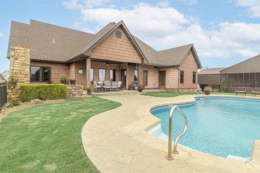 Exquisite 3-acre estate with a luxurious 3-bedroom home, pool, and versatile amenities. Discover private living within this exceptional estate nestled in NE Arkansas. The main house, a meticulously designed 2128 sq ft residence, boasts 3 bedrooms and 2.5 baths. This property goes beyond the ordinary with additional amenities that elevate it to a league of its own. The main house offers a spacious and open floor plan with stained concrete floors, a stone fireplace, and rich walnut-stained built-ins.     In fact, you'll see that the interior was thoughtfully designed with coordinating walnut-stained doors, walnut-stained shaker cabinets, wood dining room columns, and baseboards. The kitchen features granite counters, stainless steel appliances, pearlescent backsplash tiles, and abundant storage space perfect for any chef.     The primary ensuite boasts dual vanities, a roomy walk-in closet, and a custom-tiled shower. Step outside to discover an outdoor paradise consisting of a covered patio area with a grand stone fireplace that overlooks a sparkling saltwater pool enclosed by a wrought iron fence.