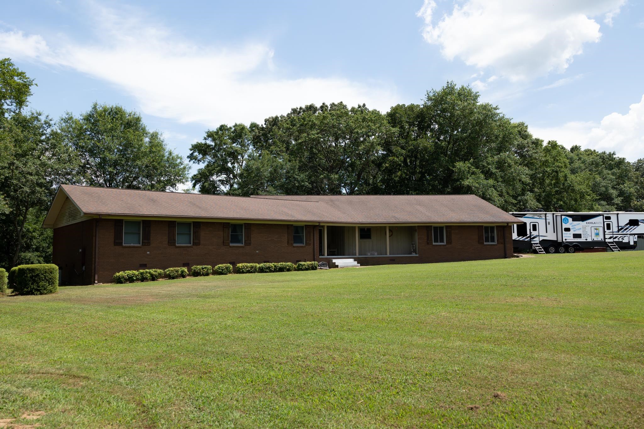 One-of-a-kind home and farm property!! This home is nestled in the Ozarks on 57.74 acres with rolling hills, lush fenced pasture, a large 50x60 shop, and a year-round creek. The beautiful 4,147 sq ft. custom home will have you captivated by the seamless blend of elegance, warmth, and natural beauty. Whether you're a farmer, outdoor enthusiast, equestrian lover, or simply enjoy working in a shop, this property has something for you! With breathtaking views, you can relax and enjoy nature at its best from your front or back porch. With two primary suites and two additional bedrooms, you have ample room for privacy and enjoyment. Benefit from a recently renovated kitchen and several other updates throughout the house. The large windows throughout the home bring the beauty of nature inside all year long with magnificent views almost anywhere in the home. This home is designed with hosting and entertaining in mind. Whether it be family or friends you have ample space in the large kitchen, dining, and living room for all to enjoy. Everyone will enjoy your entertainment room which is currently a Billiards room but has the potential for numerous uses.