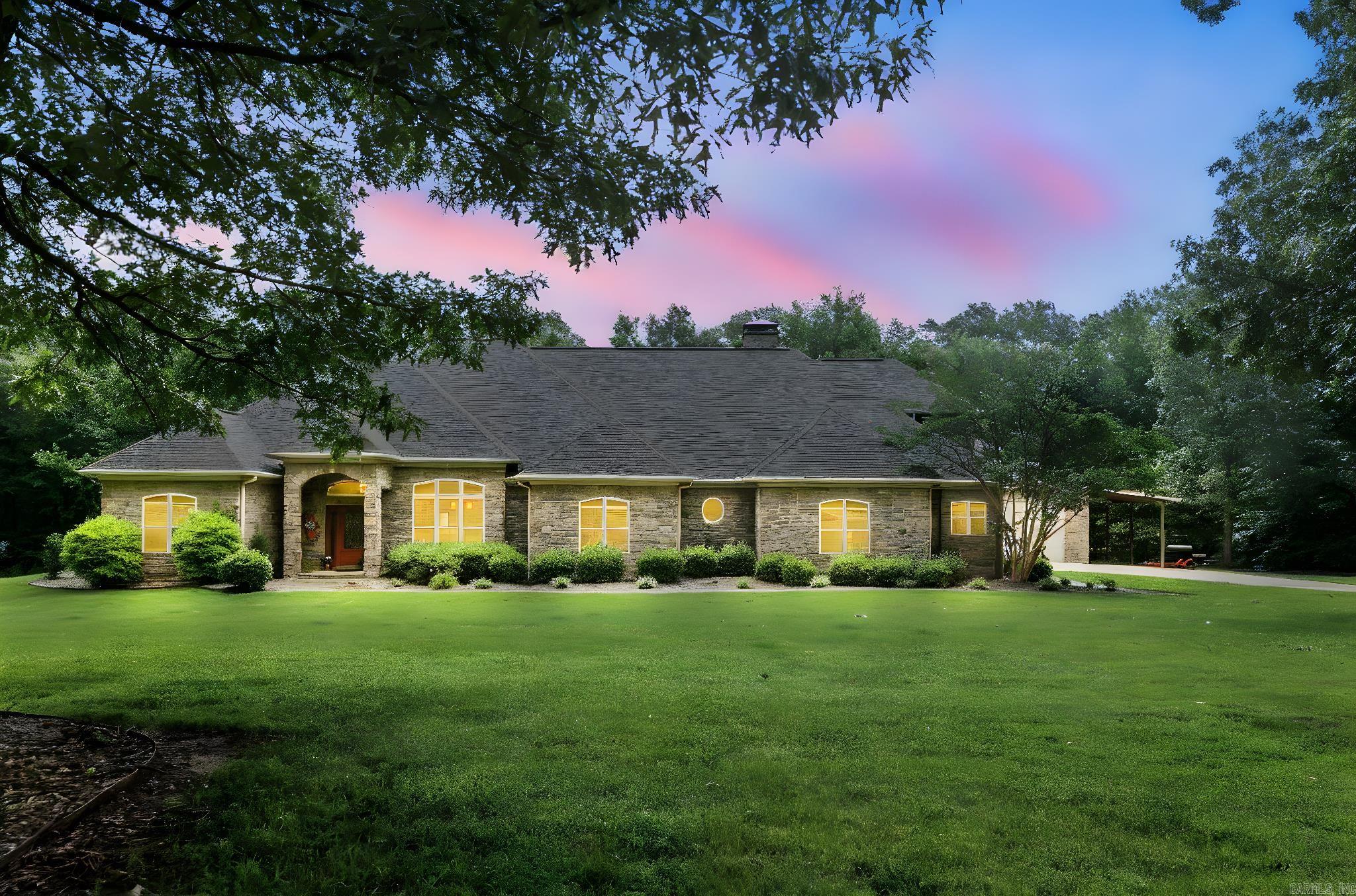 Stunning craftsman home on 2 acres, 5,118 sqft, 5bed, 3 full bath, 3 half bath and a storm room that is within Cabot city limits! From the moment you walk in, you’re welcomed by tall ceilings, arched doorways, and custom stained concrete flooring. The kitchen features granite countertops, custom wood cabinetry, a breakfast bar that comfortably seats 5, and plenty of storage. Just off the kitchen, a second living area wraps you with stone archways, a fireplace, and a wood cathedral ceiling for gathering or quiet moments. The primary suite includes a sitting area, electric fireplace, double vanities, waterline hookup for tub and walk-in closet with a private W/D. You’ll also find a private office, a guest suite with its own full bath, and two additional bedrooms connected by a Jack-N-Jill bath. Upstairs, enjoy the theater room—complete with conveying furniture and a half bath. Step outside to a covered patio with a backyard, featuring an in-ground saltwater pool, an outdoor half bath, a sink area, and a wood-burning fireplace. A 2000 sq ft shop and RV covered parking add even more value. This home isn’t just a place to live—it’s your next chapter. Call today to schedule your showing!