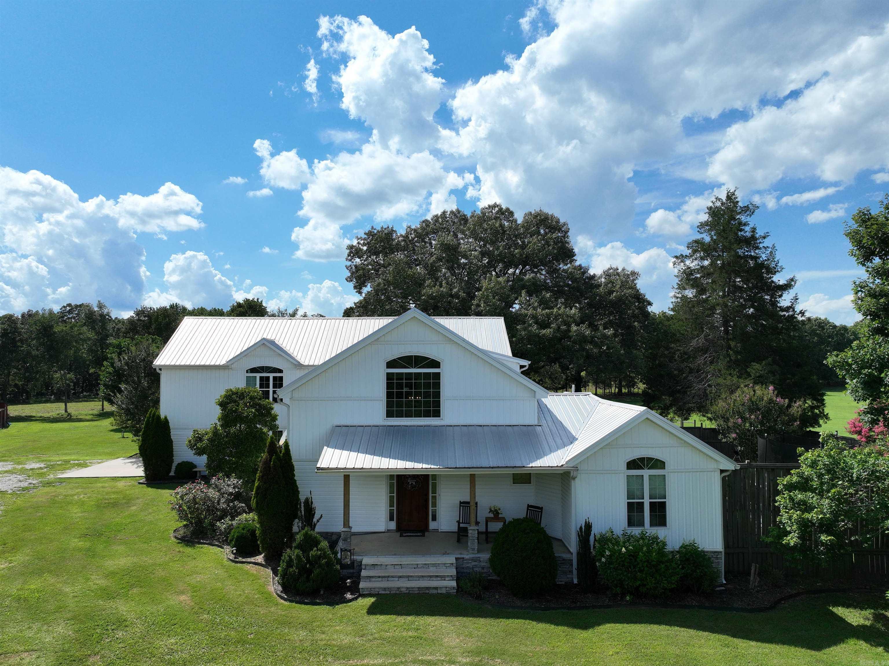 Discover the perfect blend of comfort and spaciousness with this unique property featuring two homes on 65 scenic acres. Whether you're seeking a peaceful retreat or a versatile estate, this property has it all. Main Home (4BR/3BA) approx 3707 sq, ft. Spacious 4-bedroom, 3 full bathrooms, large bonus room, ideal for entertainment with solid hardwood floors throughout. Gourmet kitchen with granite countertops commercial-grade appliances, including two dishwashers and a 6-burner propane stove with griddle Built-in pantry and freezer for ample storage Modern amenities: tankless hot water, spray foam insulation, recent A/C & heating system Relax outdoors on the expansive Trex deck overlooking the property. Guest/Secondary Home (3BR/2BA) approx 1450 sq. ft. Recently updated with a new roof, hot water heater, and A/C system Comfortable and move-in ready. Explore 65 acres of lush landscape with a seasonal creek, three ponds, and fenced pasture for livestock Two workshops and a barn for storage or hobbies Perfect for farming, animals, or simply enjoying nature This property offers the serenity of country living with modern comforts and ample space for all your needs. Donāt miss out!