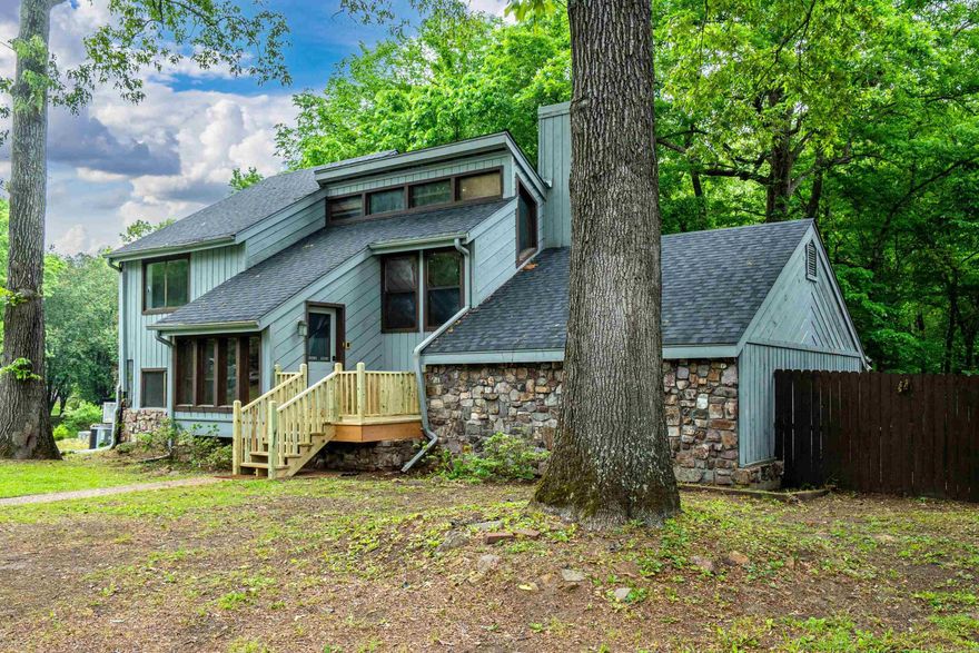 This thoughtfully updated split-level home is full of character and ample storage throughout. It features a striking floor-to-ceiling fireplace in the living room that creates a cozy focal point. On the opposite side, in the master bedroom, the double-sided fireplace brings warmth and charm against a lovely wood feature wall. Step outside to enjoy the spacious back deck, perfect for morning coffee or easy entertaining under the stars.  The lower level offers a wealth of versatile options with its own exterior access. Featuring three separate rooms along with a shower and sink, it’s ready to adapt to your needs—whether that’s a home gym, game room, workshop, crafting area, or generous storage space. Located conveniently near the college campuses, this versatile lower level also presents an excellent opportunity for rental income or guest quarters. It’s truly an ideal canvas to create additional living space or an income-producing unit, adding real value and flexibility to the home.