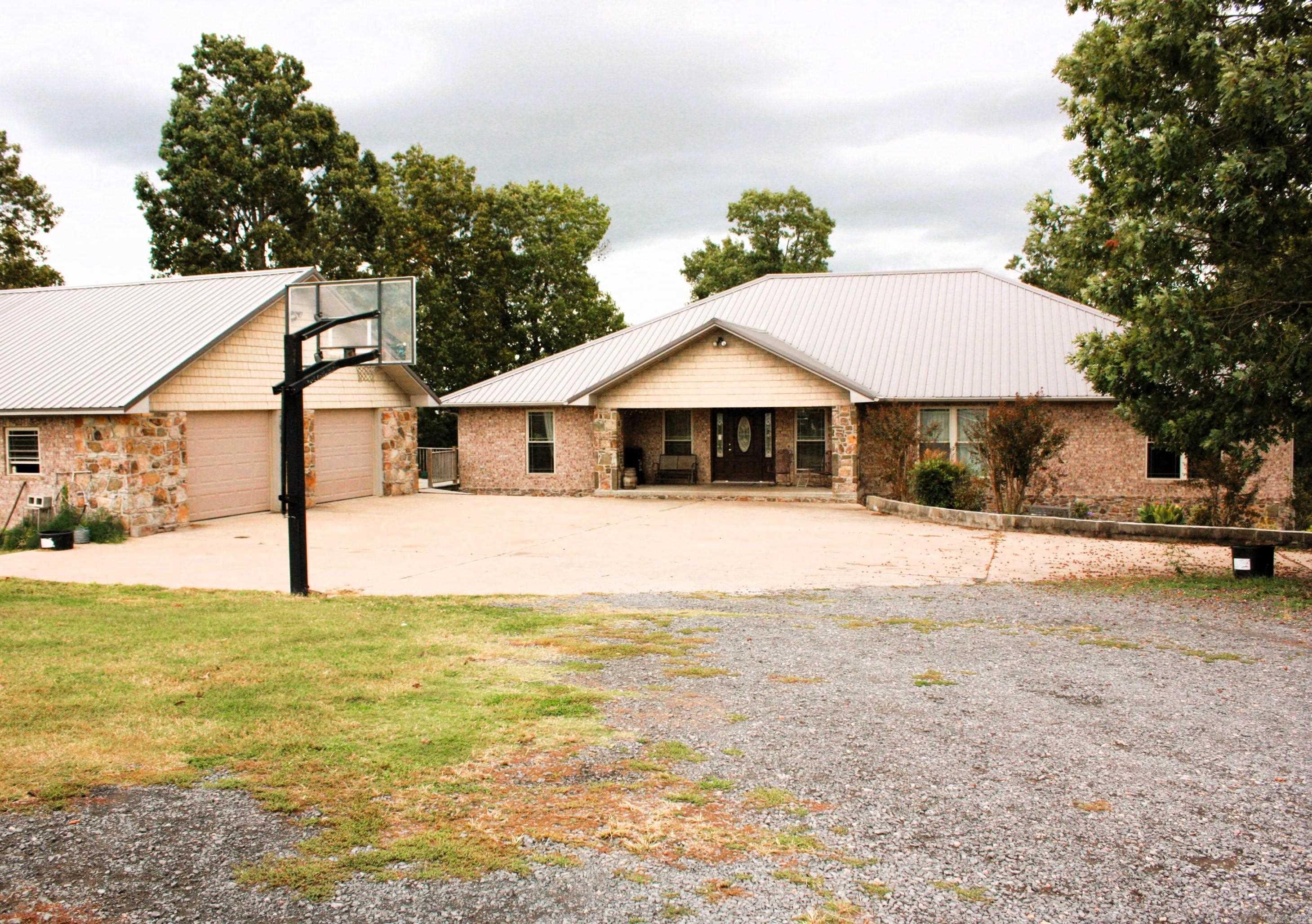 Ozark Mountain Home Nestled in the Hills of Searcy County Marshall Arkansas. Well Constructed home with 2x6 walls, native Arkansas stone and brick exterior. Interior home features three bedrooms two baths upstairs and one bedroom a half bath and large safe room downstairs. Fireplace has a whole house circulation feature. Nice detached two car garage. Sitting on just over 15 acres fenced for livestock and features 2 barns. This is a nice comfortable inviting home looking for new owners. New Roof installed May 2023.