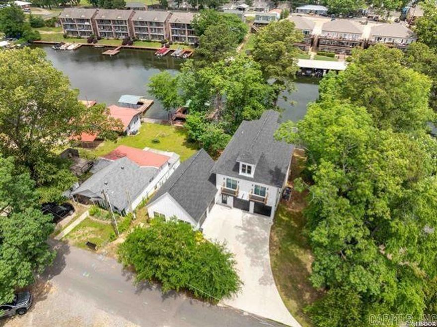 LAKE HAMILTON LUXURY! Looking for luxury, space, and lakefront living all in one? Welcome to your dream home! This stunning new construction beauty offers 4 spacious bedrooms, 4.5 baths, and an impressive 4,178 sq ft of thoughtfully designed living space — perfect as a primary residence or an investment property.  Step inside and fall in love with the open-concept main floor featuring the living, dining, and kitchen areas all taking full advantage of the expansive lake views. Enjoy custom concrete countertops, modern finishes, and designer showers that give this home a unique and upscale touch.  You’ll find 2 large bonus rooms offering flexible space for a game room, media room, office, or extra guest quarters — whatever fits your lifestyle!  Outdoors, two oversized decks provide plenty of room for entertaining, relaxing, or just soaking in the serene beauty of the water. The existing swim platform and current permit for a 2-stall boat dock make this home a lake lover’s dream!  Tucked away in a quiet neighborhood yet conveniently located near all amenities, this property offers the best of both worlds. And don’t forget the rare 4-car garage — perfect for your boats, AT