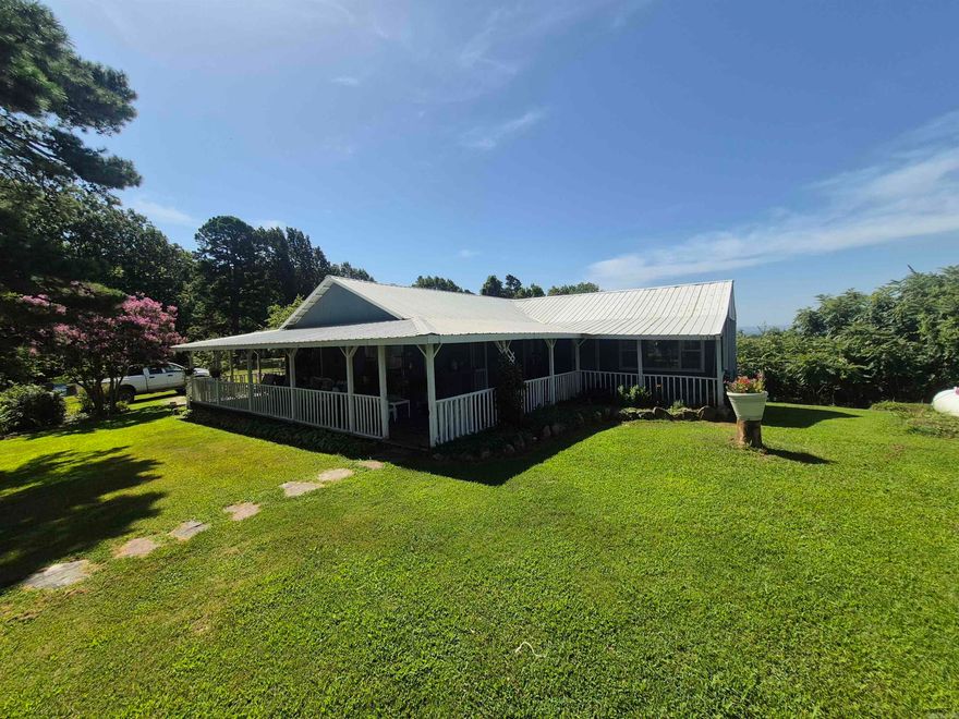 Charming 3-Bedroom,1-Bath home built around 1930, offering a peaceful setting with a mix of open garden space and spacious yard. This property features producing pear and peach trees, an established garden, greenhouse, small shop building and a storm cellar. Stay cozy with an outdoor wood burning furnace or wood stove in the living room with backup gas heat. Enjoy seasonal views from the covered porches.  A great opportunity for those seeking country living with self-sufficient touches. Also minutes away from the Buffalo National River,  Loafers Glory WMA and the Ozark National Forest.