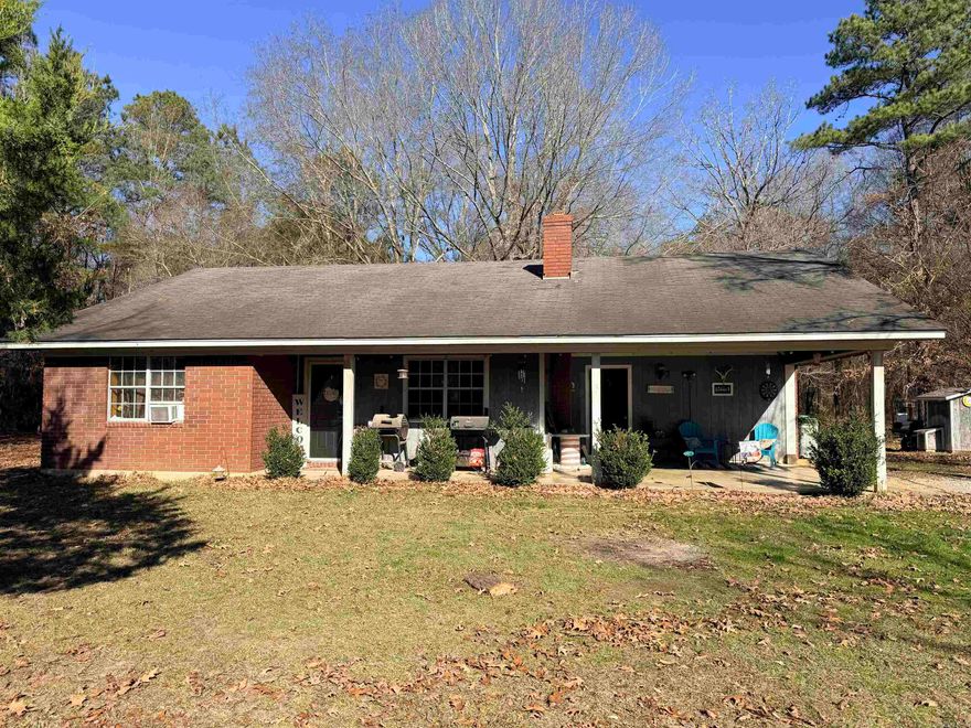 2 bed / 2 bath Ranch-style home on 2.5 acres located south of Crossett.  Built in 1994 this all electric home has an open floor plan with separate laundry room, brick hearth for wood burning stove (propane tank hookup available), covered front porch and covered back patio. There are 2 hot water heaters, one replaced in 2023 and the other in 2024. Connected to rural water, septic tank pumped 2023. Currently connected to Ashley-Chicot Fuse for fiber internet service. Original roof and central HVAC. Window units are present for cooling while central cooling is under repair.