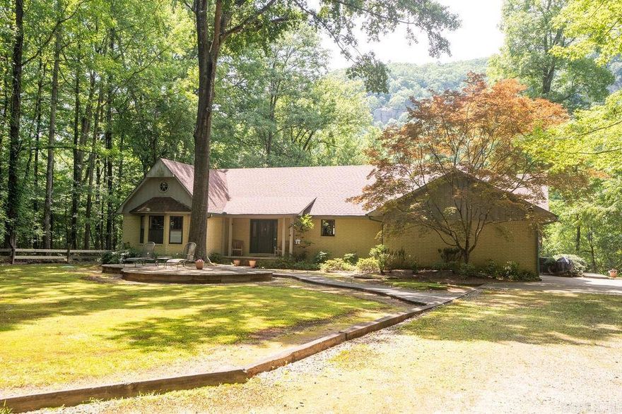 This beautiful home on the Little Red River offers serenity with over 2 wooded acres of privacy at the end of Wildflower Lane. It features 2 full "master " suites and 2 guest rooms, spacious decks and patios for outdoor enjoyment, a boat dock with electric boat lift located on one of the best streches of the River to fish, all with views of Libbby Bluff across the River. The open living/dining has a fireplace to warm you while you enjoy the views.The 2 car attached garage has permanent stairs to the attic and there is a large detached shop/garage for storing boats and lake and river toys. With over 200 feet of river frontage, you could possibly divide a 100 ft. lot to sell or if you would like to have more land there is an additional 8.1 acres available. Enjoy evenings around the firepit overlooking the river and to compliment the world class trout fishing the private subdivision lake is there for warm water fishing for bass, bream,etc. Fiber Optic internet service has been installed.Call today for your private showing.