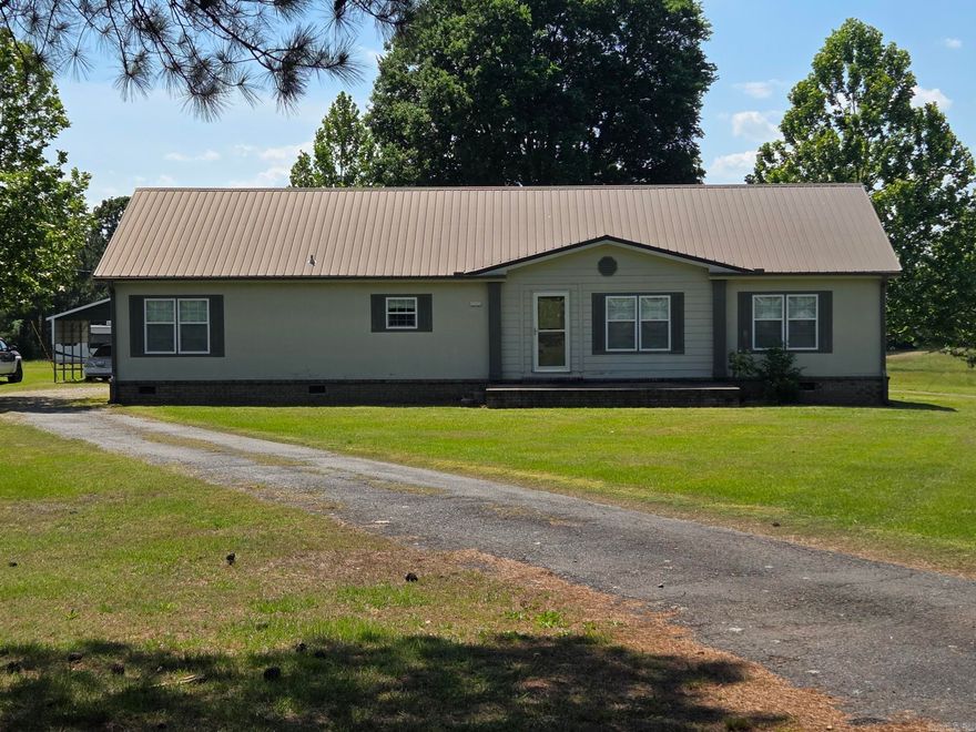 This 3 bed, 2 bath all electric one owner double wide mobile with office & large laundry room has a permanent foundation with brick around the bottom. It has a metal roof, gutters, covered back deck, storm shelter, 2 carports, storage shed & a circle drive behind the house on a paved road just South of the community of Velvet Ridge. The kitchen has an island with bar, all appliances, 2 pantries & opens up into the living & dining open space. Large spacious living room with rock fireplace. It has crown molding throughout, window seat, garden tub, double sinks with vanity, walk-in closets & more. The back 3.5 of the 10 acres is wooded so abundant wildlife to watch or hunt. Low traffic & peaceful area. See agent remarks.