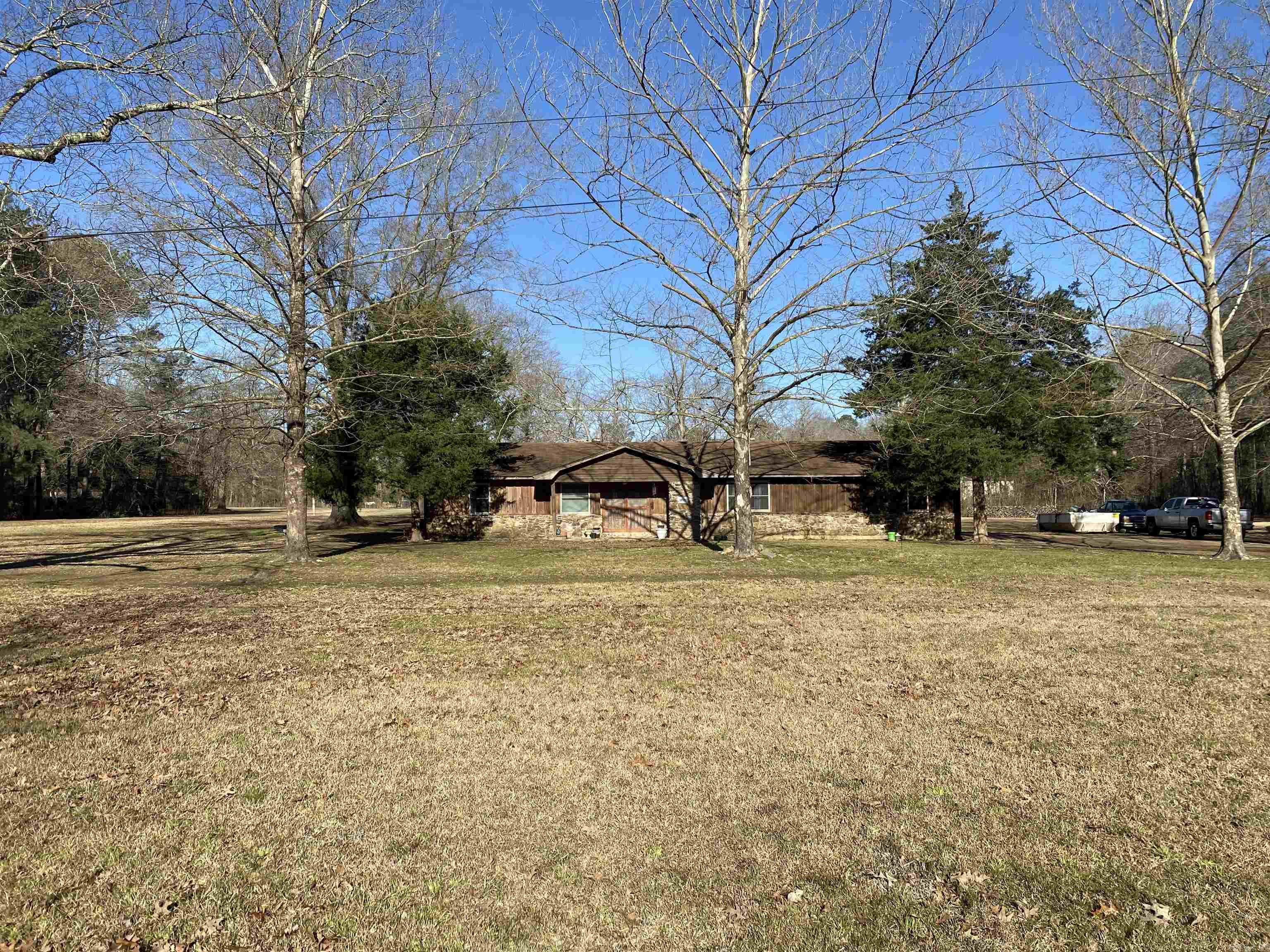 4 Bedroom / 2 Bath, 2,437 sqft ranch-style home in the country on 2.94 acres. Large living room, open kitchen, formal dining room, bonus room (formerly used as a beauty shop), craft room, laundry room, spacious covered back patio. NEW 2024 insulated easy-clean, double-hung windows with 20-year transferable warranty throughout! All electric, 2 hot water heaters. Septic pumped 2022, grinder pump rebuilt 2023, chlorinator installed 2024. Roof 2017.