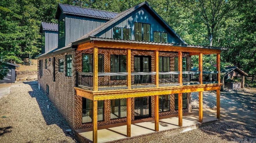 Discover Greers Ferry Lake's hidden gem - welcome to Easy St! Nestled on 8 secluded, waterfront acres, this new home embodies open-concept living, blending a scenic family room and kitchen with stunning lake views. With 3 beds on the main floor, an airy loft, and a lower level boasting a kitchenette, 2 beds, and flex space, there's room for all. 4600+ sf of luxury abounds, showcased by a 2-boat dock w/ solar lifts, 2-car garage, 10-car garage, beer garden, and storage galore. Your lakeside paradise awaits!