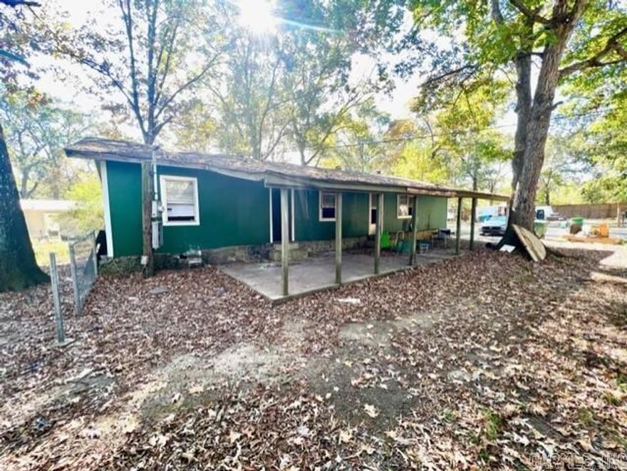 Convenient location. decent curb appeal, spacious living area and bedrooms, on a large level lot, with mature trees. Room to add a mobile home for additional rental income, or have a spacious backyard. House built around a mobile home. Previous tenants used space heaters and window units. Definitely needs work. Good potential for a 4/2 with 1500+ sq feet. Carport is deep for tandem parking or 1 car and a covered patio. Shed in back and property is partially fenced. See agent remarks!