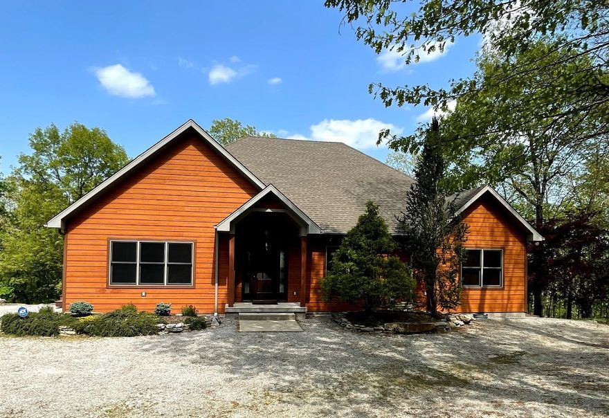 Custom built home on 3.3 acres m/l with beautiful views of Lake Norfork. There is a main house and 2 separate guest houses.