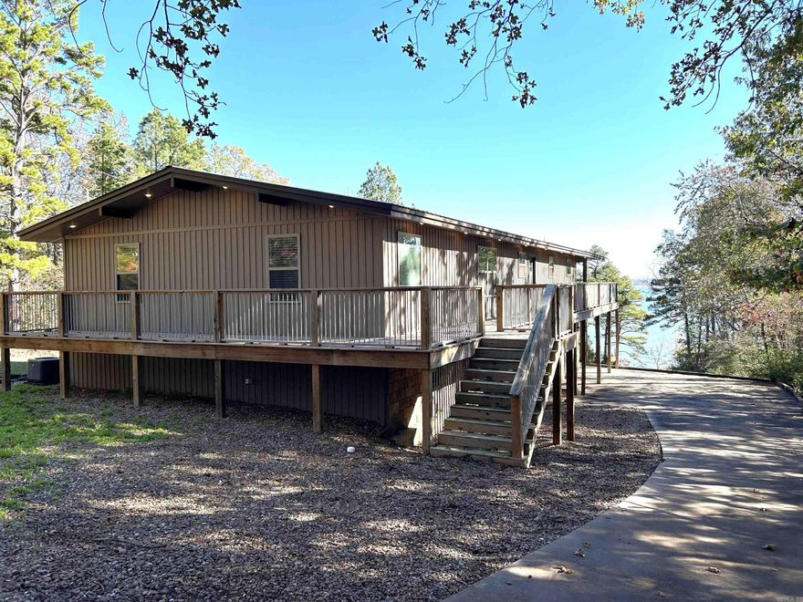 Stunning Lakefront Home with Modern and Updated Amenities!!! This exceptional lakefront property showcases what lake living should be. Complete maintenance free exterior so you can focus on fun and not work. Inside you will appreciate the 4 bedrooms, extra living and entertaining spaces, granite countertops, and open concept floor plan. A large covered deck overlooking the water adds more room to entertain along with large windows allowing the 8-10 mile unrestricted water-view to fill the home. This property features a super easy walk to the water, large 2 car garage and storage area, plus a covered boat parking garage at top of the hill to store boats, etc.. This is the home you've been looking for so call and schedule your showing today because there is only 1 like it.