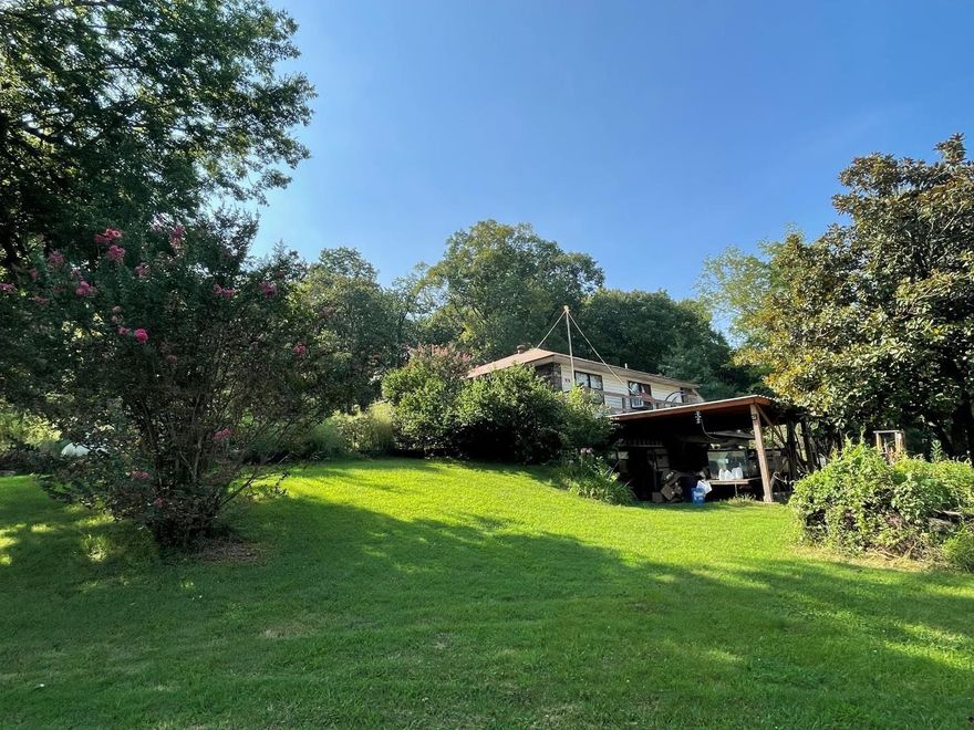 2 Homes on 7 acres!  The main home features 2 bedrooms, laminate flooring throughout, a wrap-around deck, an enclosed porch, and a basement that can be accessed from the inside or outside.  The basement is mostly unfinished, but you could easily put a couple of bedrooms in it.  The second home is a 2 bedroom, 1 bath that has currently been rented to the same person for 6 years.  There is a 3rd building that was a house at one time, but was most recently used as shelter for animals. There is also a storage building, some fencing, a carport, and pretty, scenic views of the surveyed acreage!