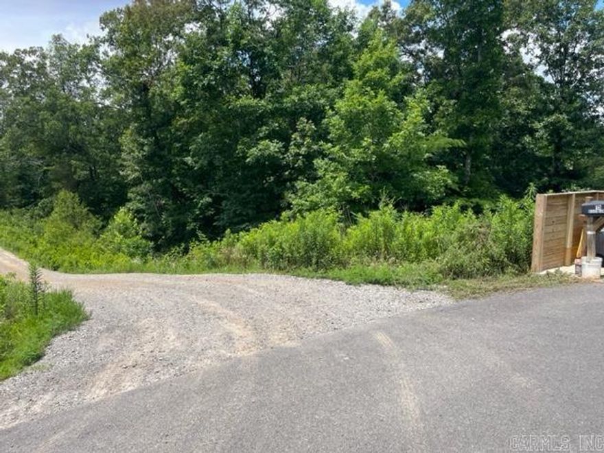 1.5 acres with Vilonia Water and Entergy Elec. Will need septic tank. Mostly woods. Located at Gated Community. Access inside gated Community. No mobile homes allowed.