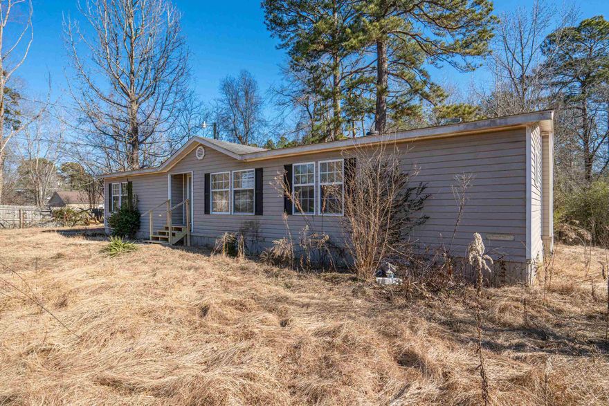 Charming Double-Wide Mobile Home on Nearly 1 Acre – Move-In Ready!  This beautifully updated 3-bedroom, 2-bathroom double-wide mobile home offers 1,568 sq ft of comfortable living space on a generous .92-acre lot. Recently refreshed with new flooring, new paint, and mini blinds throughout, this home is ready for its next owner!