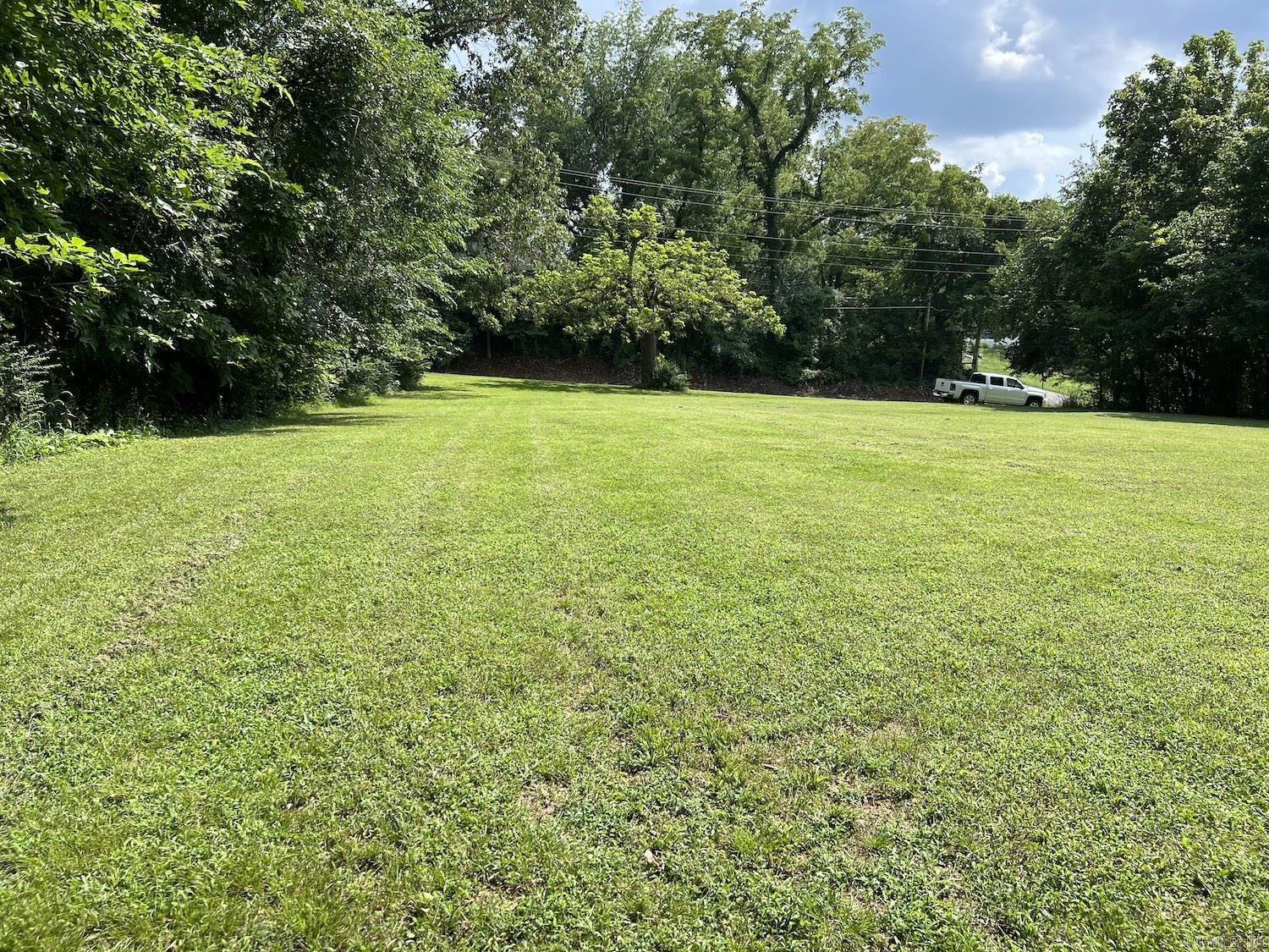 ACREAGE/CITY LOT Outstanding, mostly level, ideal building site for a home, Air BnB, or a get away cabin. Where you can enjoy the scenic Mammoth Spring area. Spring River for water activities, swimming, floating and Trout and other types of area fishing. Would also be a great location for various businesses with State Highway frontage. City utilities accessible, electric on Street.