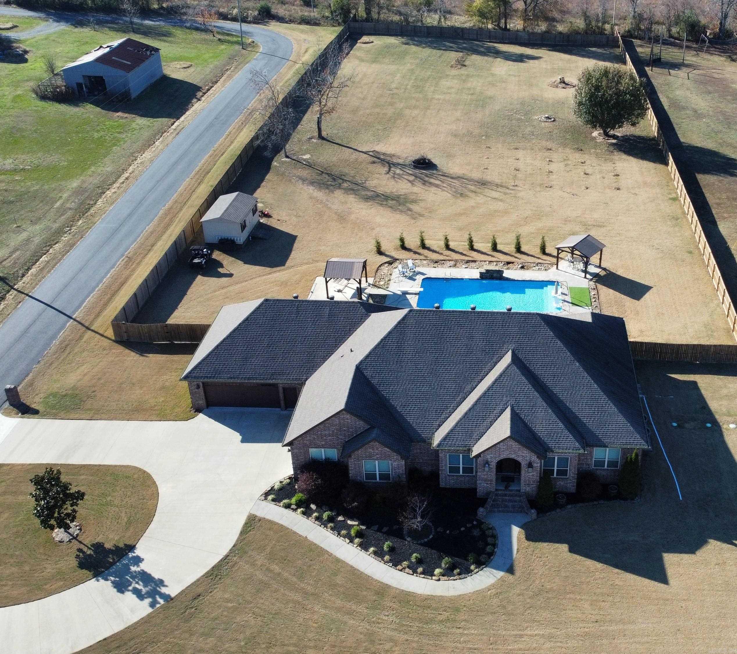 Welcome to this stunning 4 bedroom, 3.5 bath home situated on 3.09 acres of picturesque land with a 20'x44' in-ground pool! Built in 2017, this 3215 sq ft residence offers a perfect blend of luxury and natural beauty. The kitchen features a commercial refrigerator/freezer, double convection oven, 2 sinks, an island and a huge pantry. Spacious living room has fireplace and overlooks patio/pool area. Master bedroom is separate with master bath having 2 vanities, tiled shower and walk in closet that is attached to the laundry/mud room. The other bedrooms are also spacious with walk in closets. TWO 2 car garages...one is 22x31 and makes a great SHOP while the other has storm/shelter saferoom and a staircase to the floored attic for additional storage. Covered patio with outdoor kitchen, completely fenced back yard, storage building with electricity, 2 covered pavilions that also have electricity. Plum trees, apple trees, blackberry and blueberry bushes..... Just gorgeous!!!!