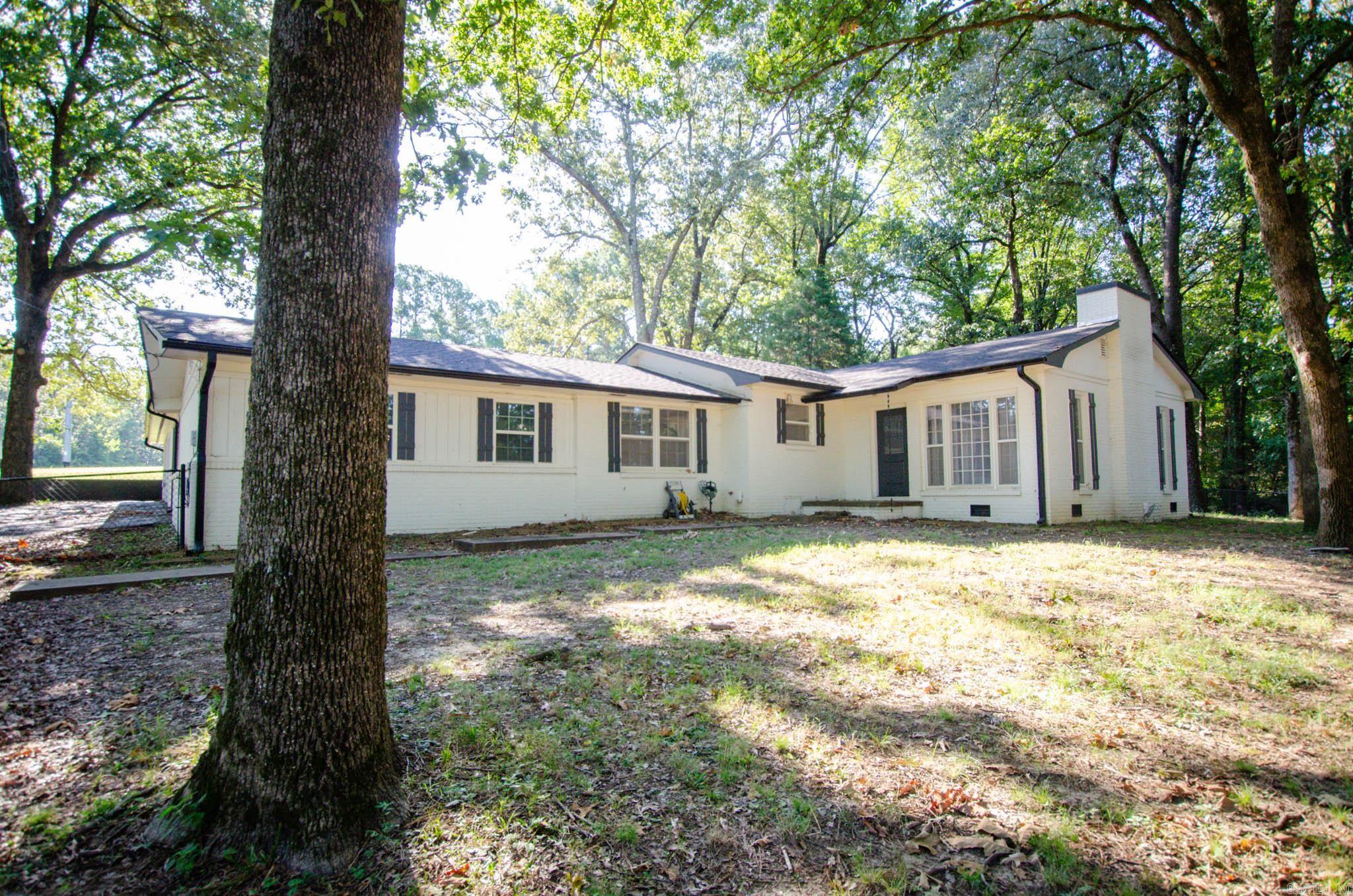 Tucked inside the city limits but sitting pretty on 3.31 acres, this recently remodeled gem gives you the best of both worlds: room to spread out and convenience to everything. Step inside and fall in love with the crisp white paint, warm tongue-and-groove wood ceilings, and a cozy feature wall that makes this home feel both modern and cozy. Car lovers, DIYers, and hobbyists, get ready! You'll find a large shop building with electricity, a 2-car carport, plus an attached 1-car garage with storage room. Plenty of space for toys, tools, and projects. Completely remodeled in 2022, this home is move-in ready with a fresh vibe that blends style and comfort.