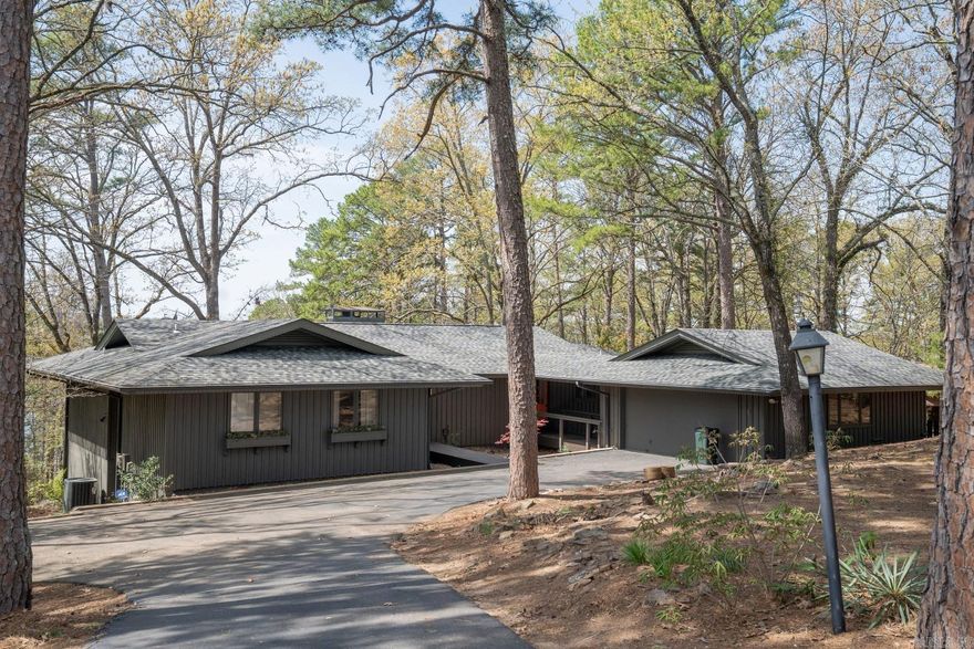 LAKEFRONT HOME located between Eden Isle Marina and Heber Springs Marina!  Woodland Point is a beautiful area with lake on both side of the street!  This lovely 4-bedroom, 3-bath, almost completely furnished home, designed by Frank McGary (who studied under E. Fay Jones), includes 2 living areas, beautiful stained wood vaulted ceiling in the upstairs living, nicely updated kitchen with stainless appliances, wood floors, large master suite with lake views, screened porch on main level is great for grilling and entertaining, large deck, 2-car garage, new roof in 2020, new paint (inside and out!) in 2021, and great landscape lighting!  A well-cared-for property!