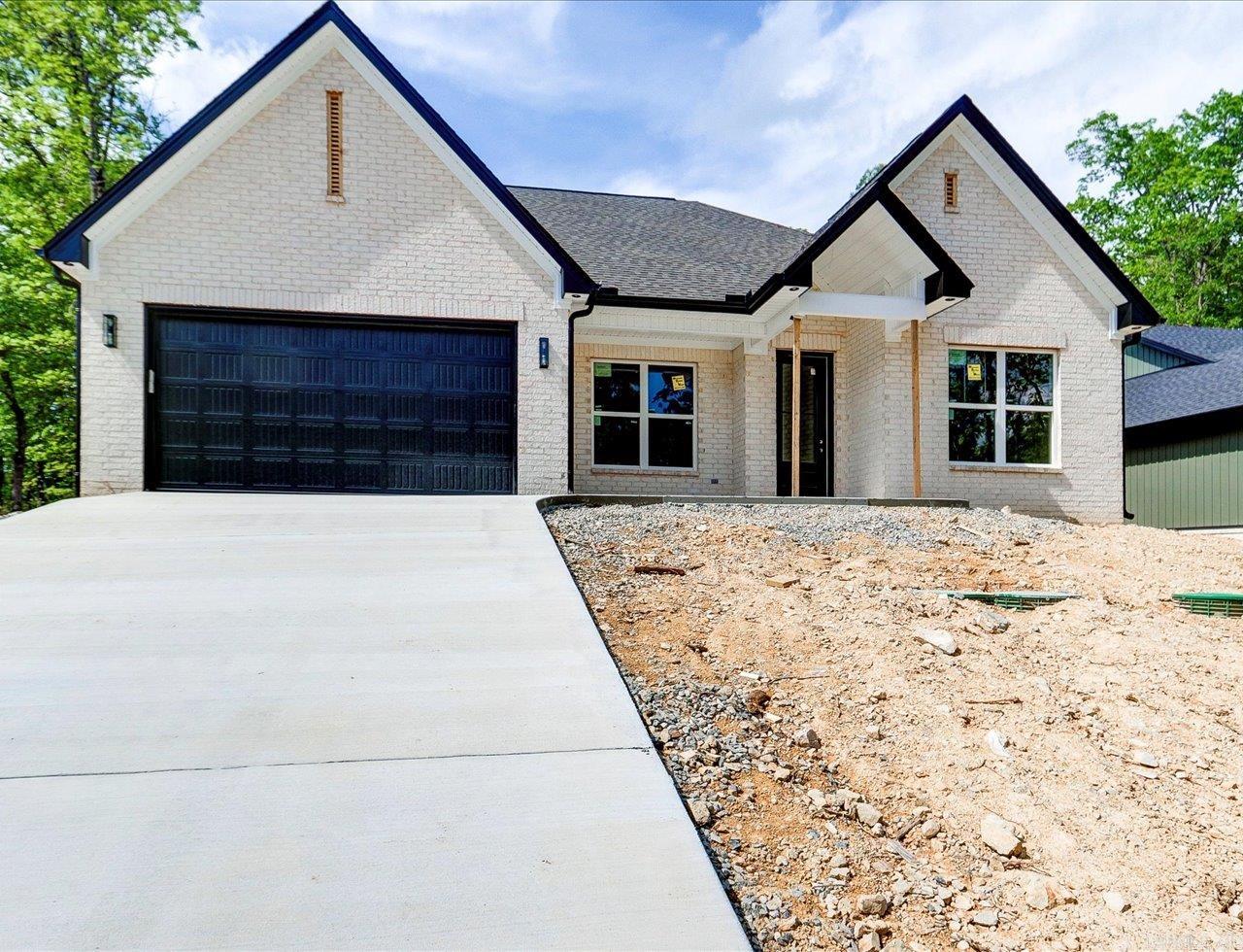 Discover this stunning new construction by Charles Anderson Homes! This residence boasts every luxury you could desire. The foyer opens up to a spacious Great Room with an inviting open floor plan and a stylish recessed electric fireplace. The kitchen and dining area showcase beautiful granite countertops, a range alcove with surround, and a large island that serves as additional dining space. Enjoy exquisite ceiling and cabinet fixtures throughout the home. The private Master Suite features double vanities, hardwood and tile flooring, a garden tub with upgraded tile surround, a custom tile shower, and two walk-in closets. On the opposite side, you'll find two bedrooms along with a guest bath and laundry room. Step outside to the covered porch, complete with an outdoor fireplace for cozy evenings. Plus, enjoy peace of mind with a 2-10 Home Buyers Warranty! Estimate Completion Date within 30 days.