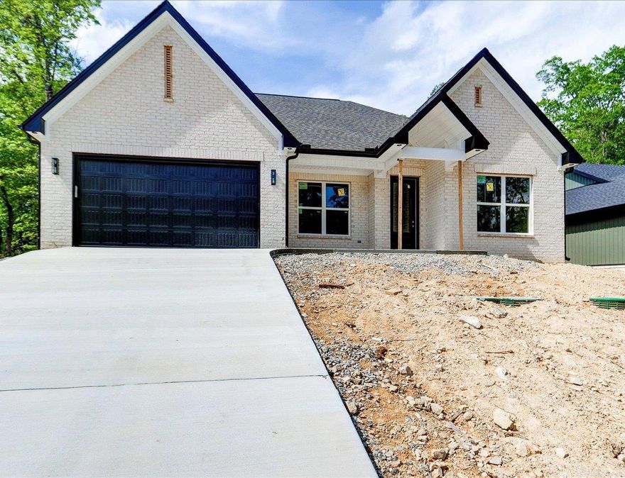 Discover this stunning new construction by Charles Anderson Homes! This residence boasts every luxury you could desire. The foyer opens up to a spacious Great Room with an inviting open floor plan and a stylish recessed electric fireplace. The kitchen and dining area showcase beautiful granite countertops, a range alcove with surround, and a large island that serves as additional dining space. Enjoy exquisite ceiling and cabinet fixtures throughout the home. The private Master Suite features double vanities, hardwood and tile flooring, a garden tub with upgraded tile surround, a custom tile shower, and two walk-in closets. On the opposite side, you'll find two bedrooms along with a guest bath and laundry room. Step outside to the covered porch, complete with an outdoor fireplace for cozy evenings. Plus, enjoy peace of mind with a 2-10 Home Buyers Warranty! Estimate Completion Date within 30 days.