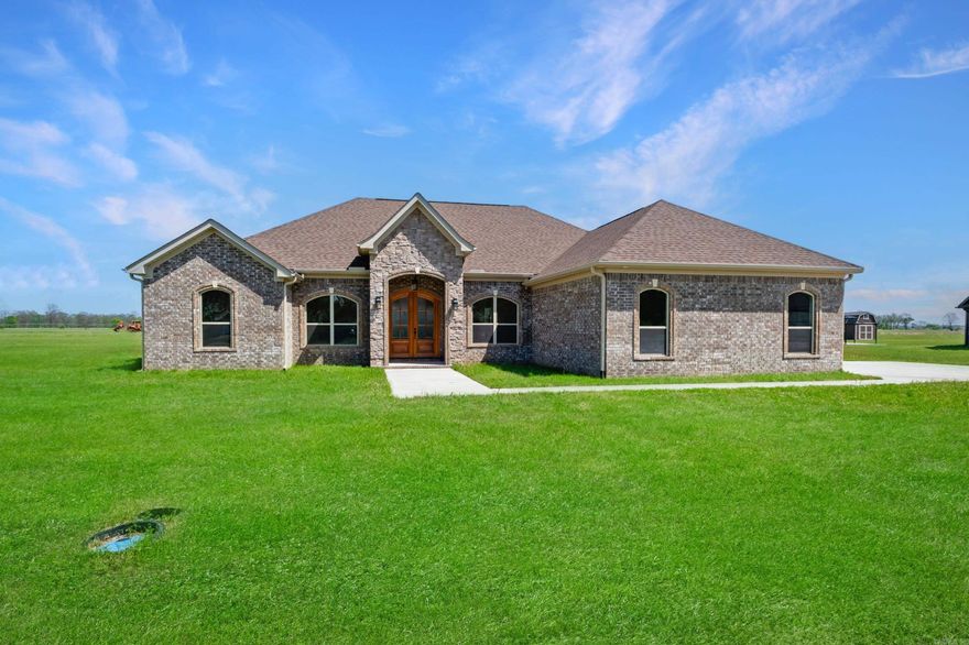 Beautiful Home on 1.55 Acres in Gated Community!  Set on a peaceful 1.55-acre lot in an exclusive gated subdivision, this home offers an ideal blend of luxury and tranquility. The open floor plan and 10-foot ceilings create an airy and inviting feel throughout.  The chef’s kitchen is a showstopper with a large island, high-end stainless steel appliances, gorgeous countertops, and a solid stone backsplash—perfect for entertaining or everyday living.  The huge master suite is a true retreat, featuring a spa-like walk-in shower with seating, a massive walk-in closet, and direct access to the laundry room for ultimate convenience.  Enjoy the peaceful surroundings from your screened-in porch, perfect for relaxing and soaking in the serene setting.  This home is the perfect blend of luxury, comfort, and privacy—come experience it for yourself!