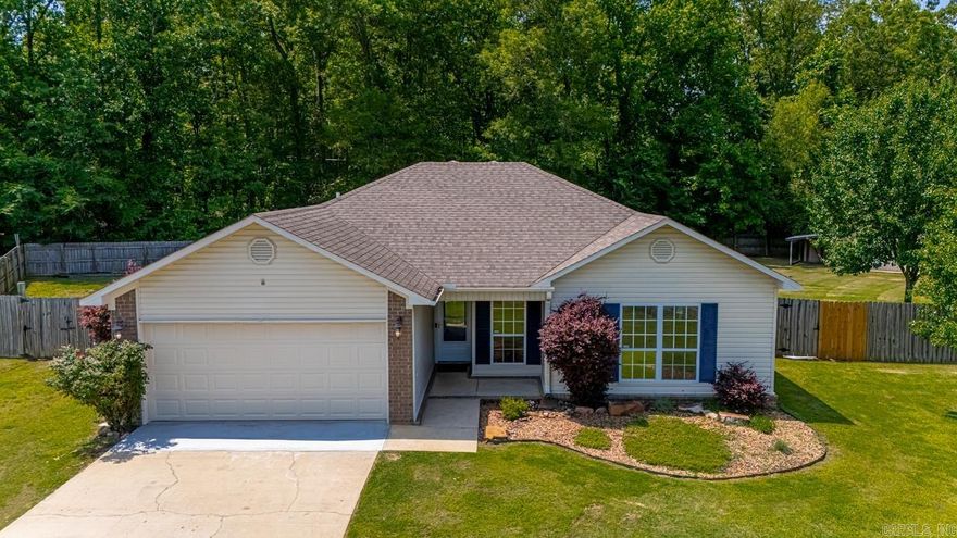 Nestled in a peaceful cul-de-sac within a welcoming subdivision, this delightful three-bedroom, two-bathroom house offers the perfect blend of comfort and convenience. Step inside to discover a warm and inviting living space, designed to accommodate all your family needs. The garage features an epoxy-painted floor that promises durability and easy maintenance.  This home includes a cozy back porch complete with a swing, where you can relax and enjoy the serene views of the large fenced-in backyard. This outdoor haven boasts a variety of features, including a firepit and a raised garden. Along the property line is a running creek giving opportunity for exploration. Additionally, there's an outbuilding equipped with electricity and flanked by lean-tos on each side, offering versatile space for hobbies or storage. This property is located close to the freeway making everything you need just a short drive. In summary, this charming house is an excellent choice for anyone looking for a comfortable, well-equipped home in a prime location. Don't miss the chance to make this inviting property your new home.