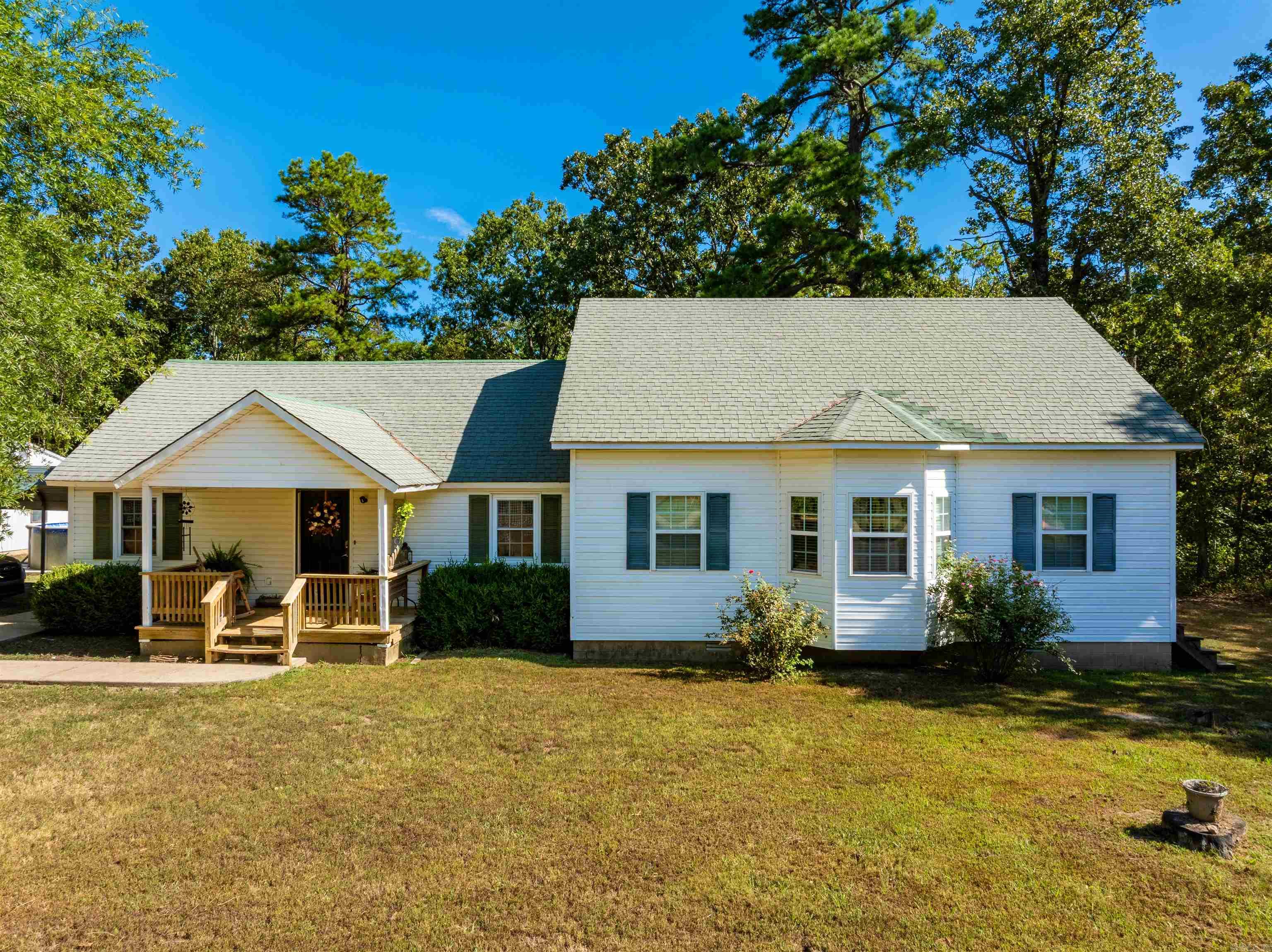 This gorgeous country home sits on 13± acres in Sharp County, just minutes from Hardy, AR and the Spring River. With mature shade trees, wooded acreage, a pool, and a shop, it offers the perfect mix of comfort, charm, and outdoor living. Inside, the spacious dining area flows into a remodeled kitchen (2020) with a large island and room for a full table. The living room anchors the home, leading to the primary suite with walk-in closet and large bath. Another bedroom off the dining area includes a sitting area with access to the pool deck. Upstairs, a large open bonus room is perfect for a game room, theater, or additional bedroom. Updates include roof (2009), two central heat/air units (1998 & 2009), and complete rebuild to the studs in 1997. The 13± acres include a two-car garage/shop with space for living quarters and plumbing for a bathroom, plus plenty of room for hunting, recreation, or livestock. Utilities include well water, propane (owned), and central HVAC. Located on paved Hwy 175, this home offers privacy yet is close to historic Hardy for shopping, dining, and the Spring River, and within ~1 hr 20 min of Jonesboro for healthcare, university, and major retail.